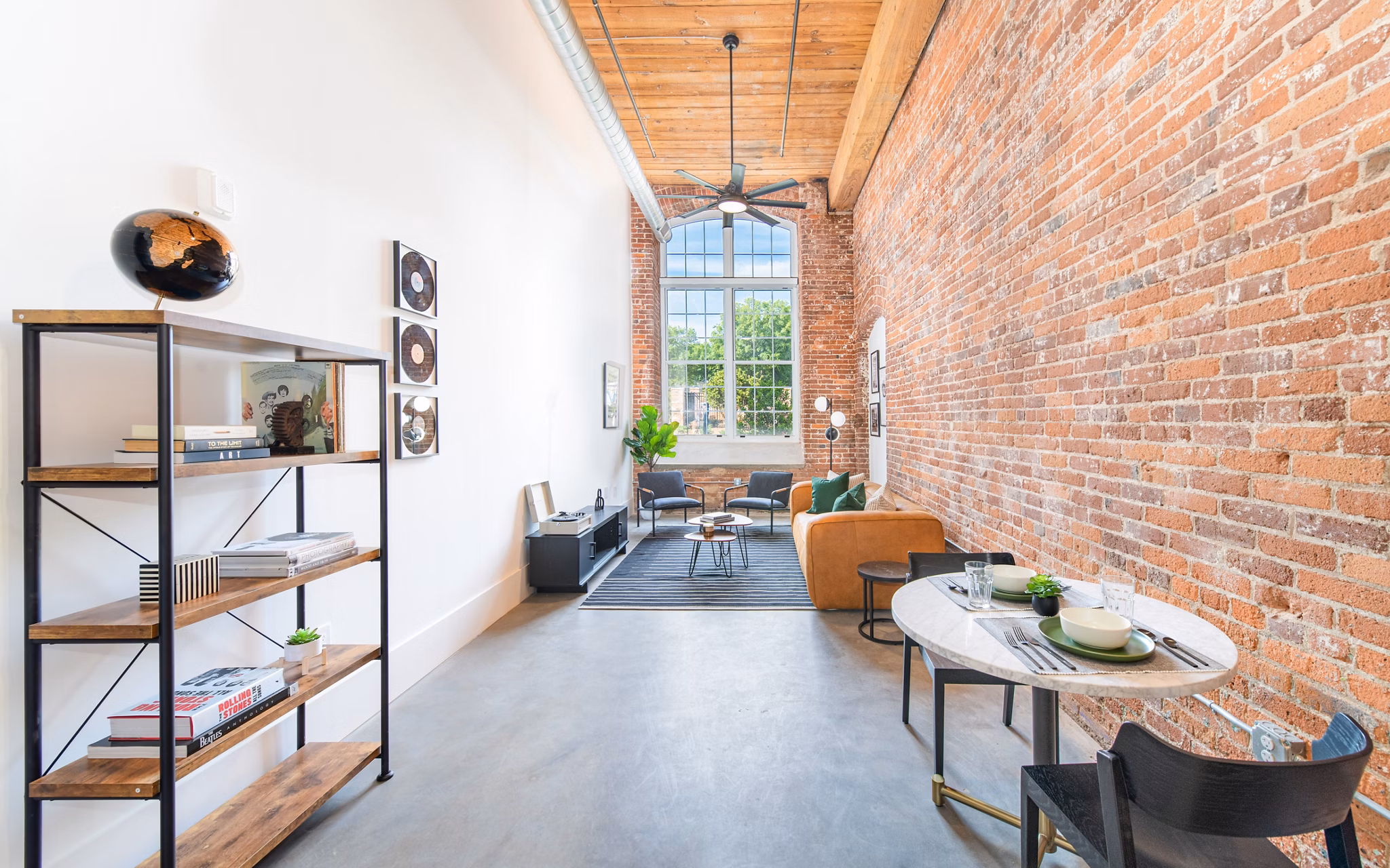 Dining area featuring modern furniture and industrial design at The Lofts at Woodside Mill Apartments