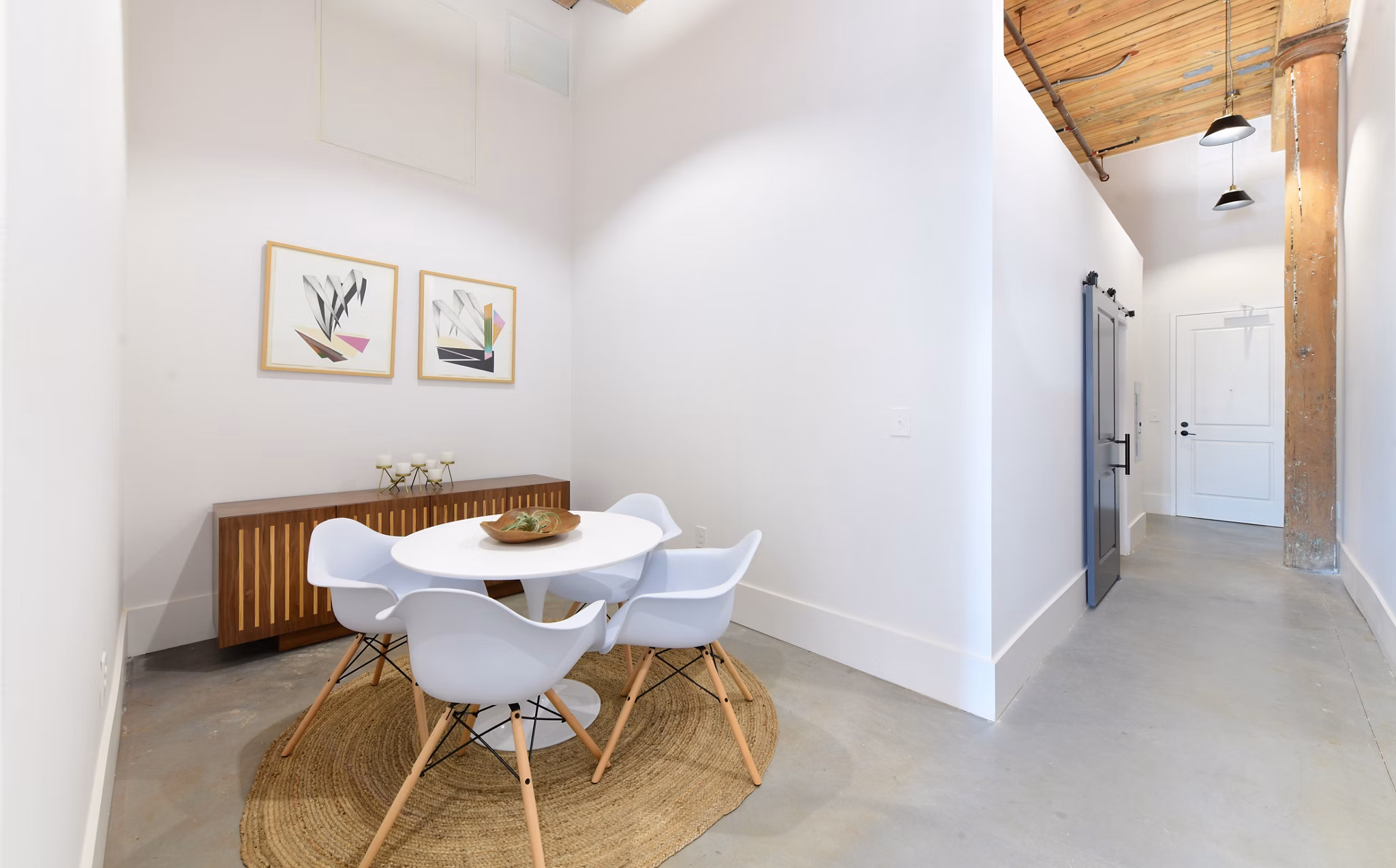 Dining area with industrial design and exposed brick walls at The Lofts at Woodside Mill Apartments