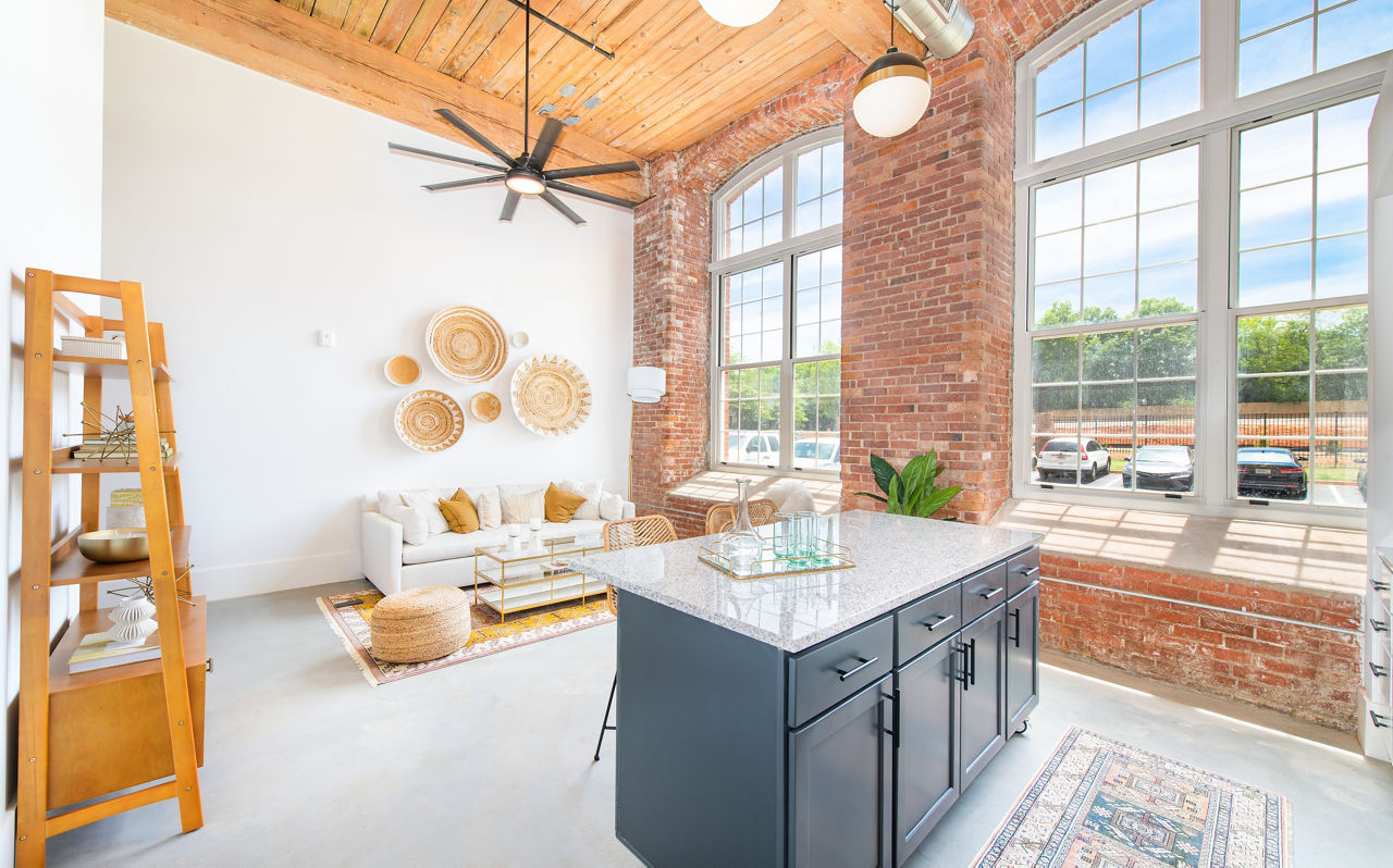 Modern kitchen with stainless steel appliances in The Lofts at Woodside Mill Apartments