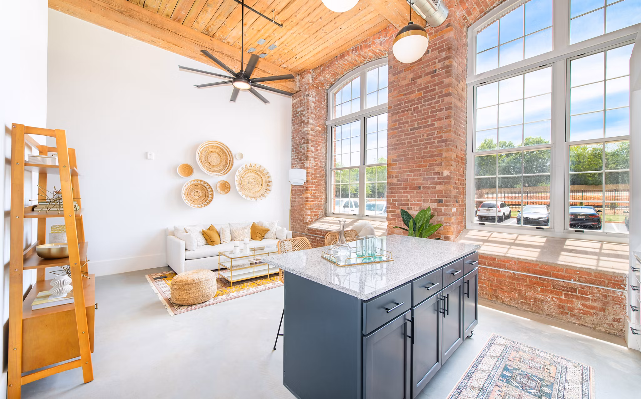 Modern kitchen with stainless steel appliances in The Lofts at Woodside Mill Apartments