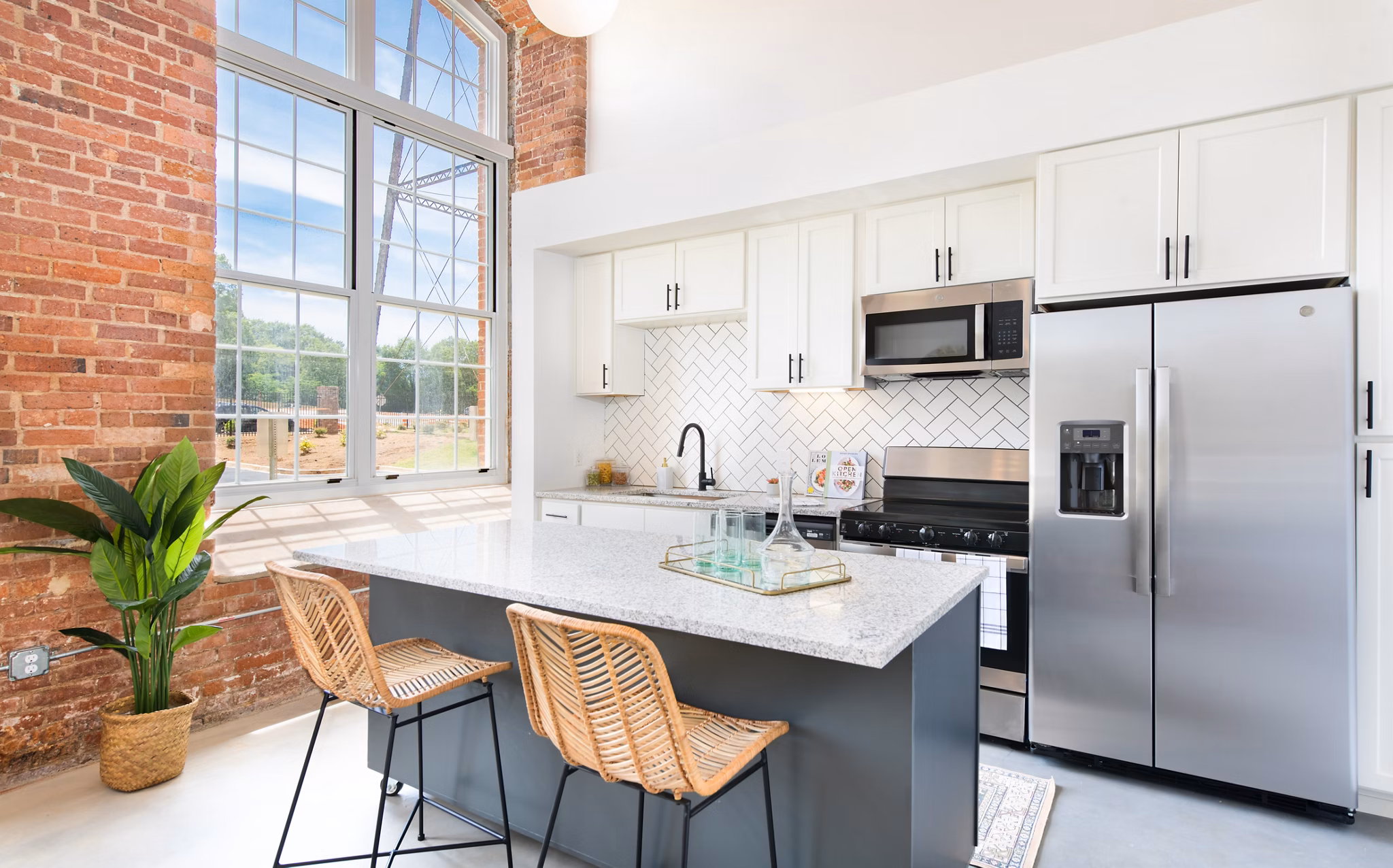 Modern kitchen with stainless steel appliances at The Lofts at Woodside Mill Apartments