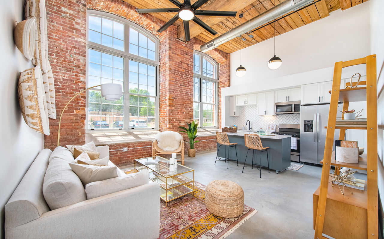 Modern living room with cozy seating and natural light at The Lofts at Woodside Mill Apartments