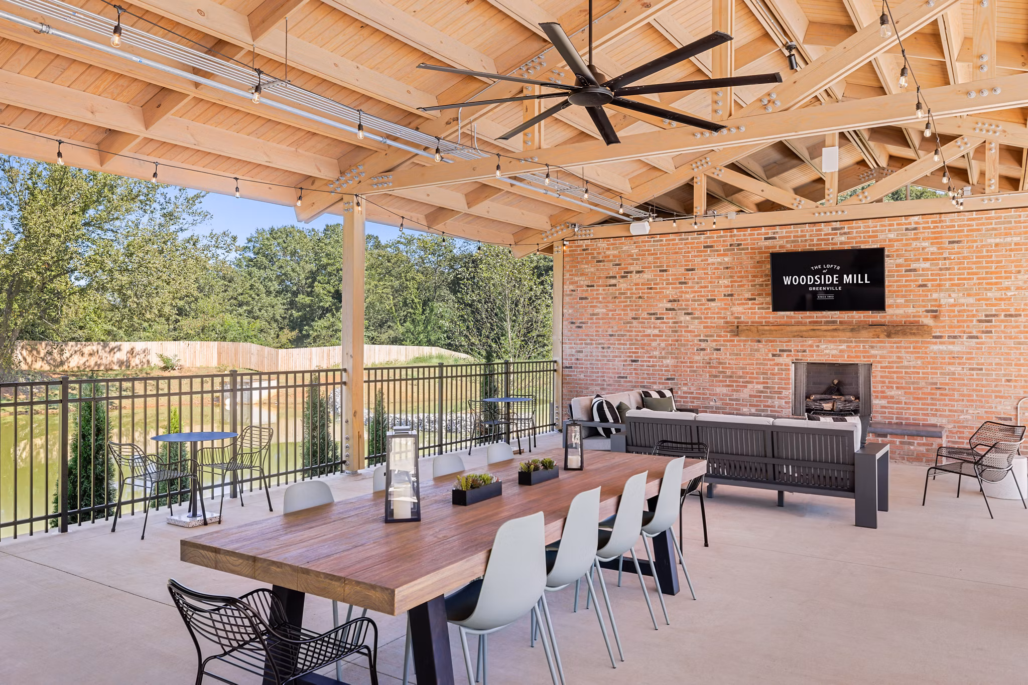 Charming patio with outdoor seating at The Lofts at Woodside Mill Apartments, perfect for relaxation and leisure activities