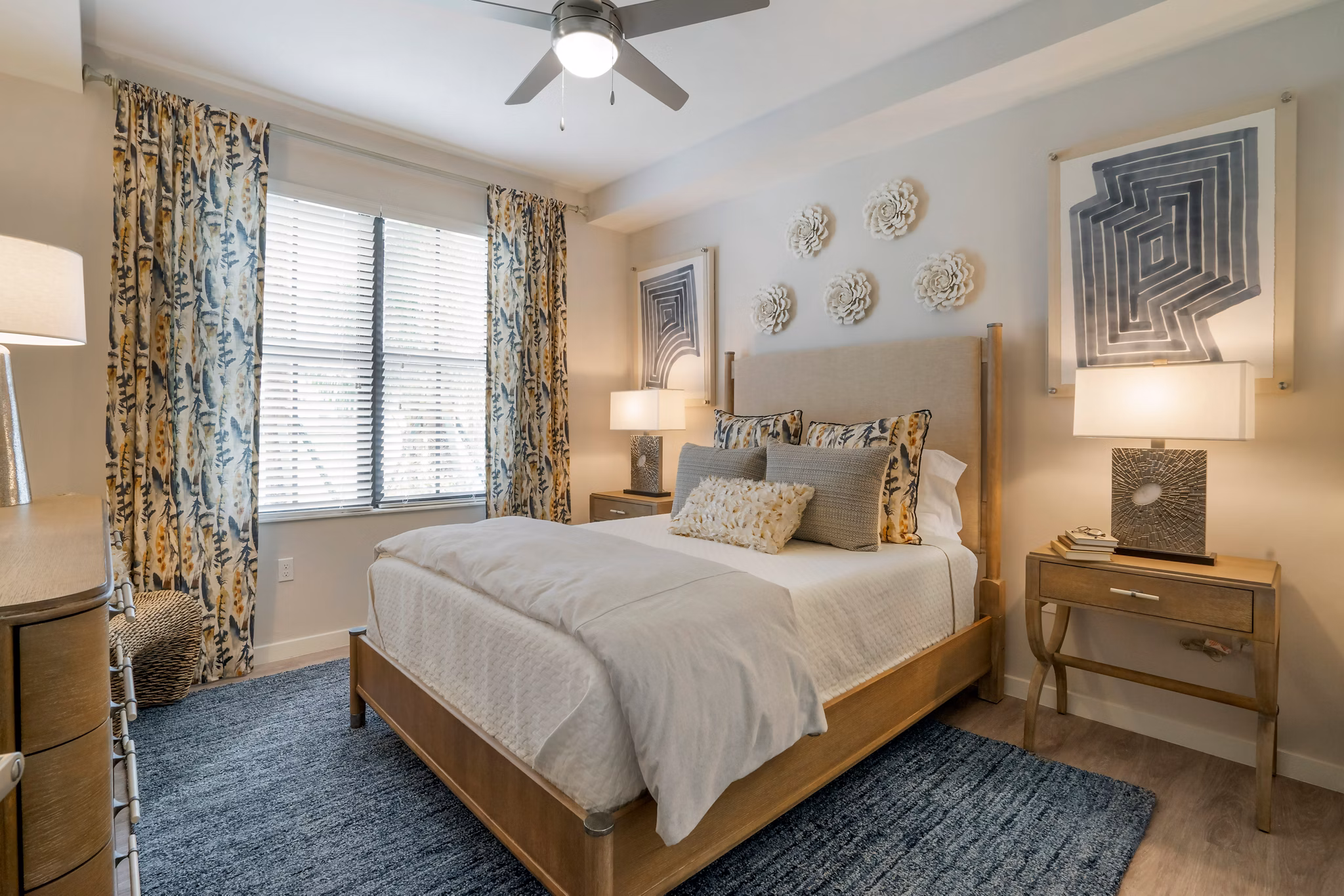 Cozy bedroom featuring plush bedding and natural lighting at Lago Apartments