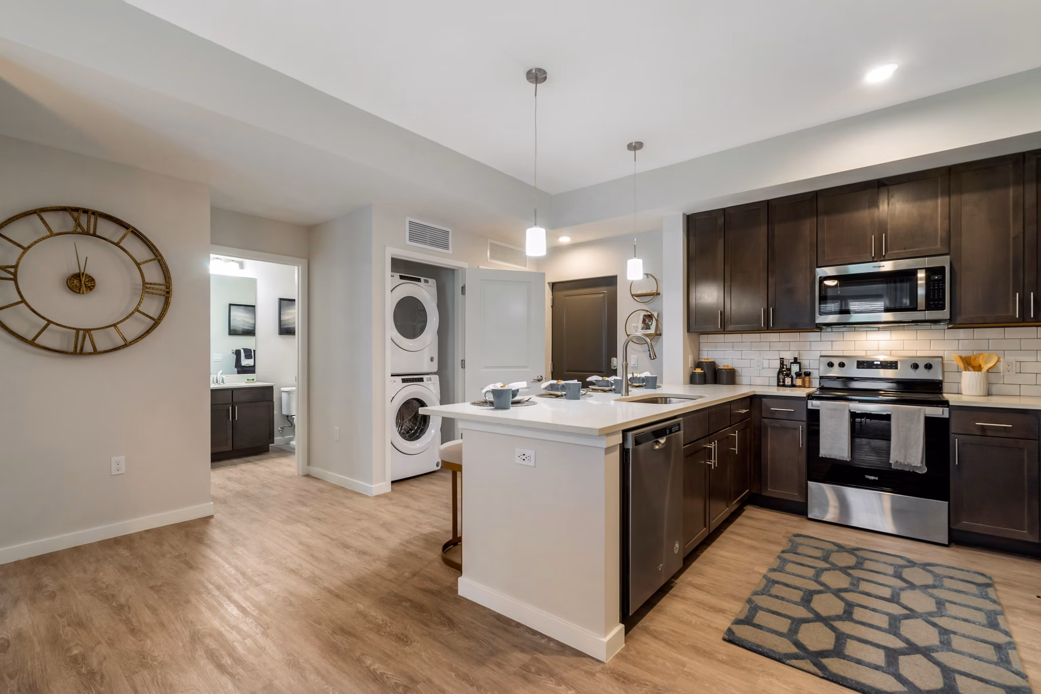 Kitchens with modern appliances and sleek countertops at Lago Apartments