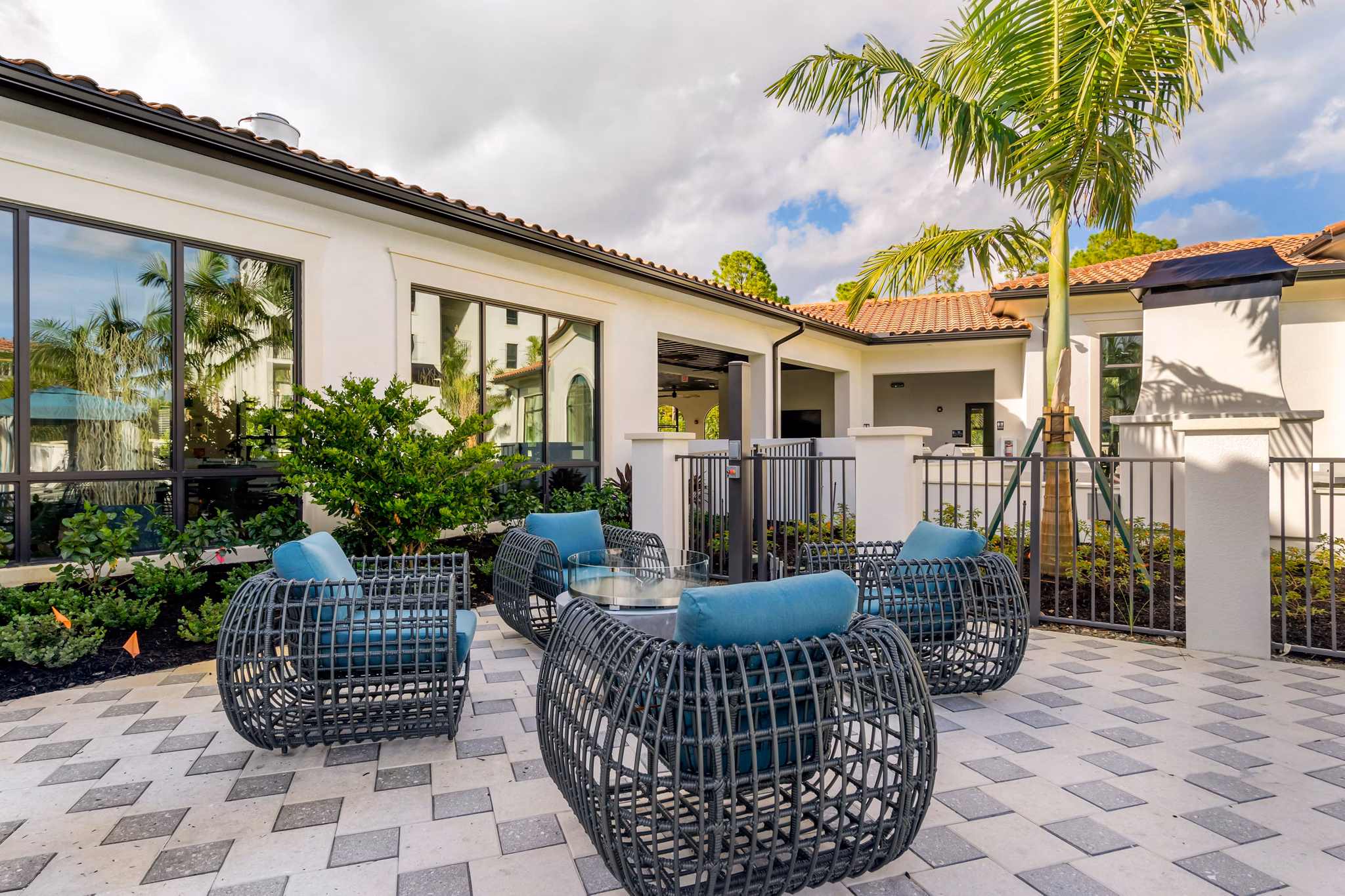 Lago Apartments: Serene courtyard with lush greenery and seating areas in a luxury community