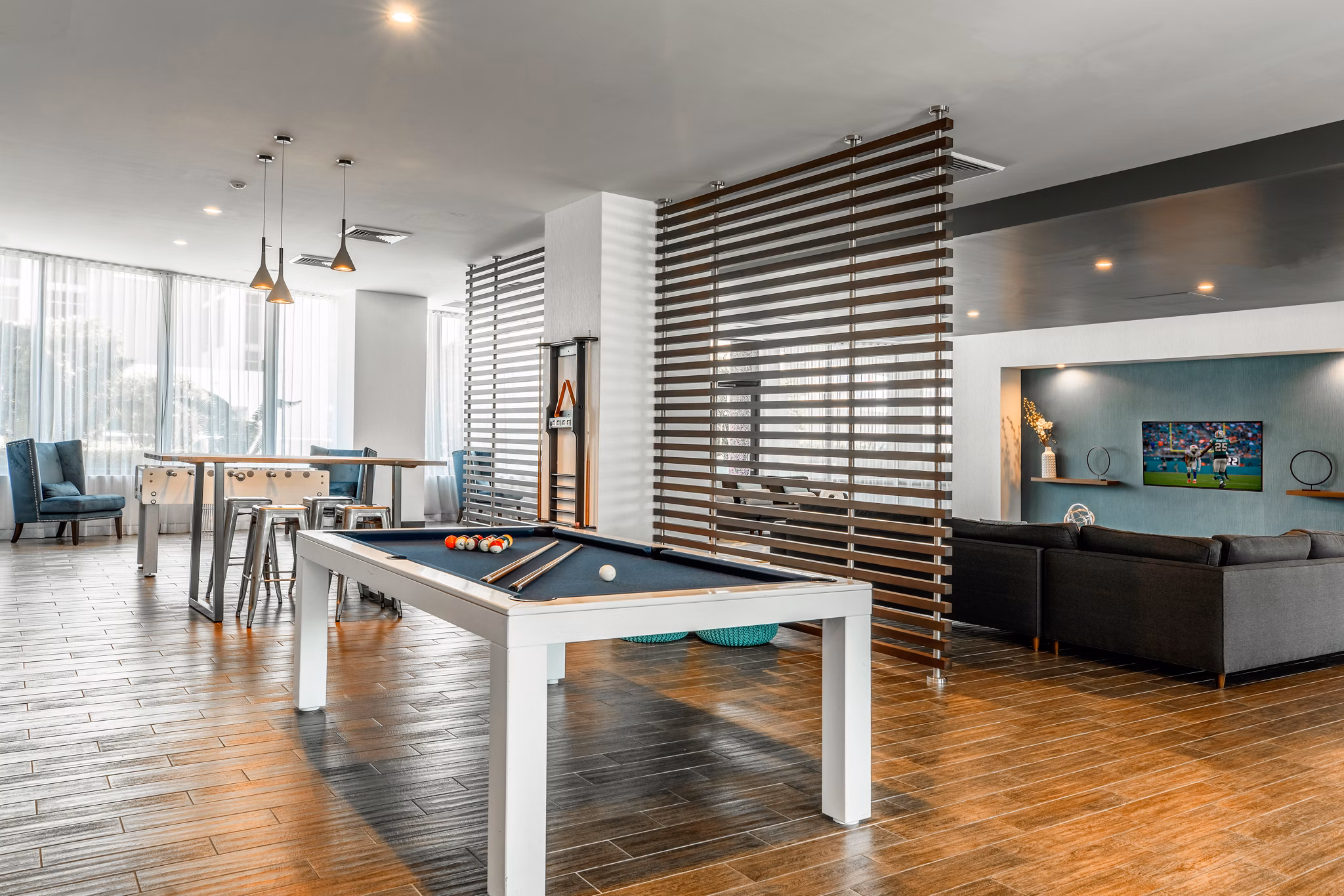 Vibrant game room with pool table and lounge seating at Midtown 5 Apartments, perfect for socializing and entertainment