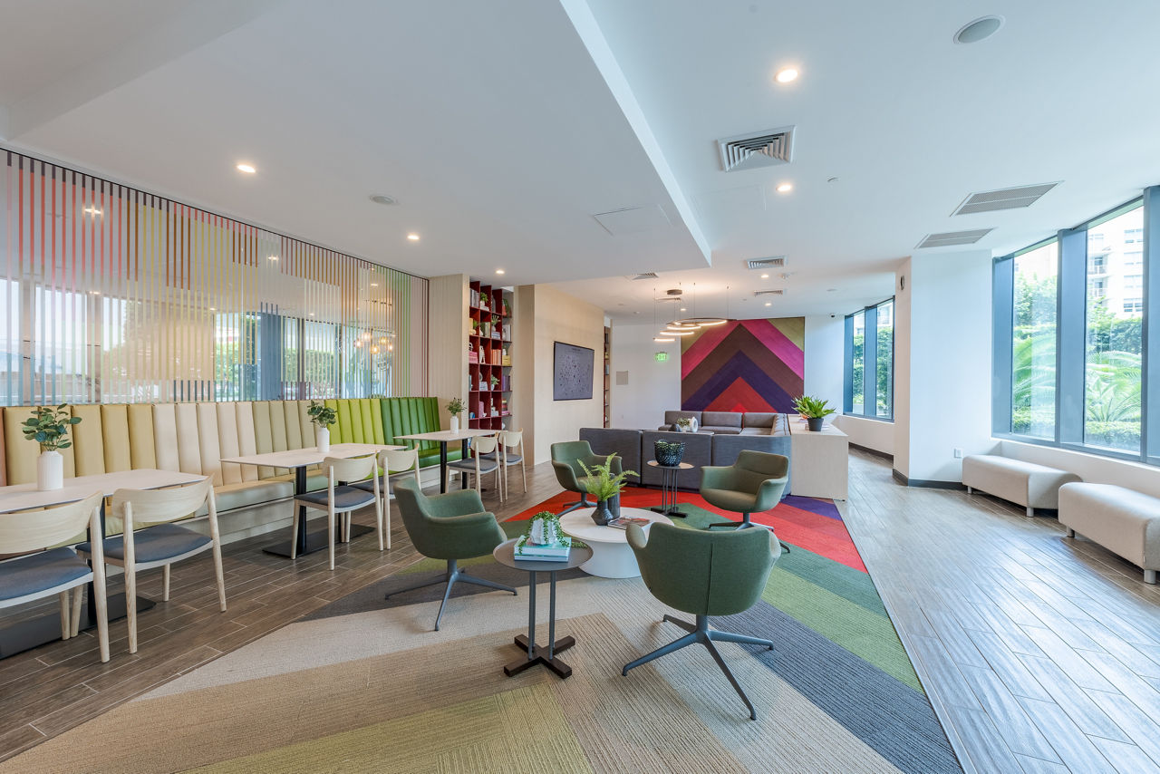 Clubhouse featuring modern design and cozy seating areas at Midtown 5 Apartments in Miami