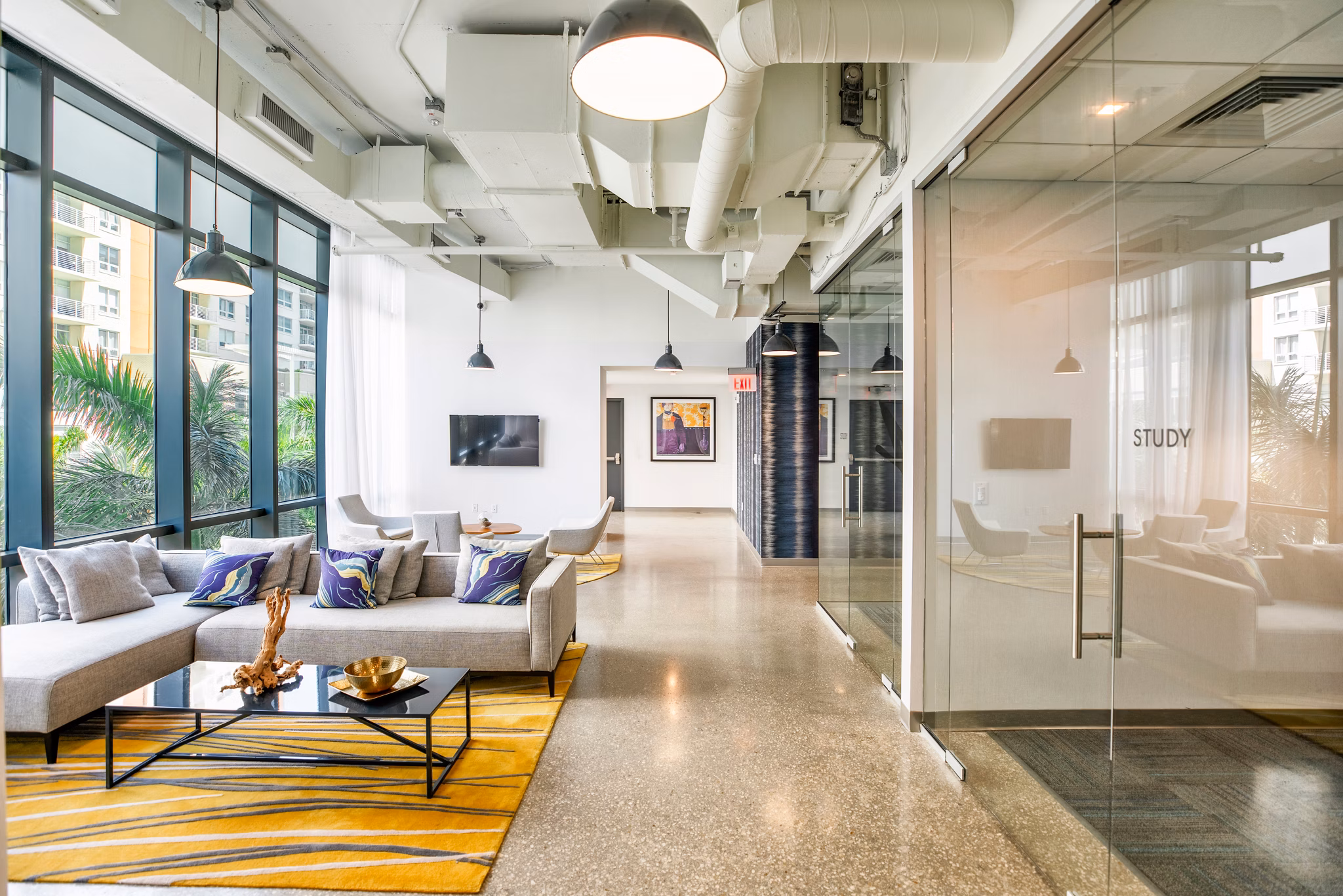 Clubhouse featuring modern design and cozy seating areas at Midtown 5 Apartments in Miami