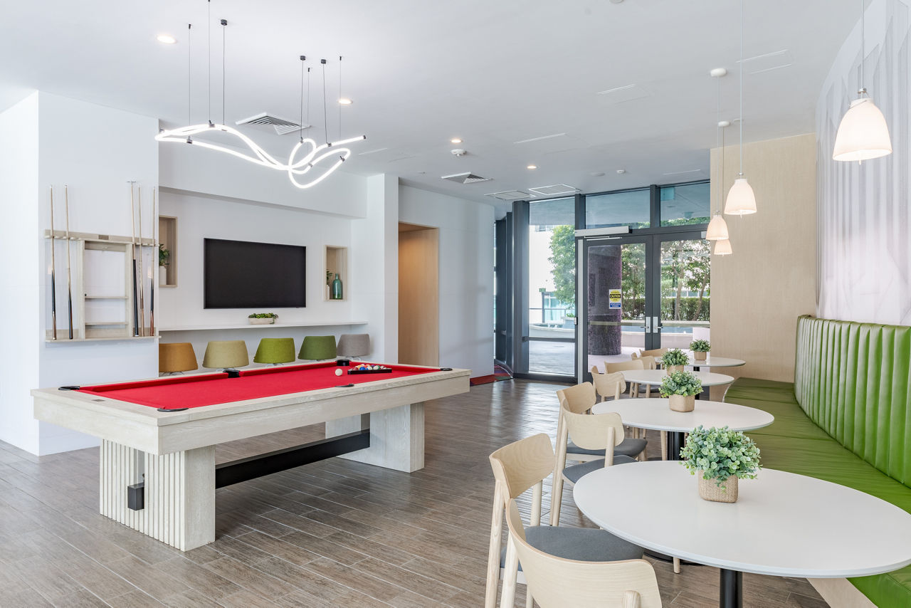 Clubhouse featuring modern decor and ample seating at Midtown 5 Apartments in Miami