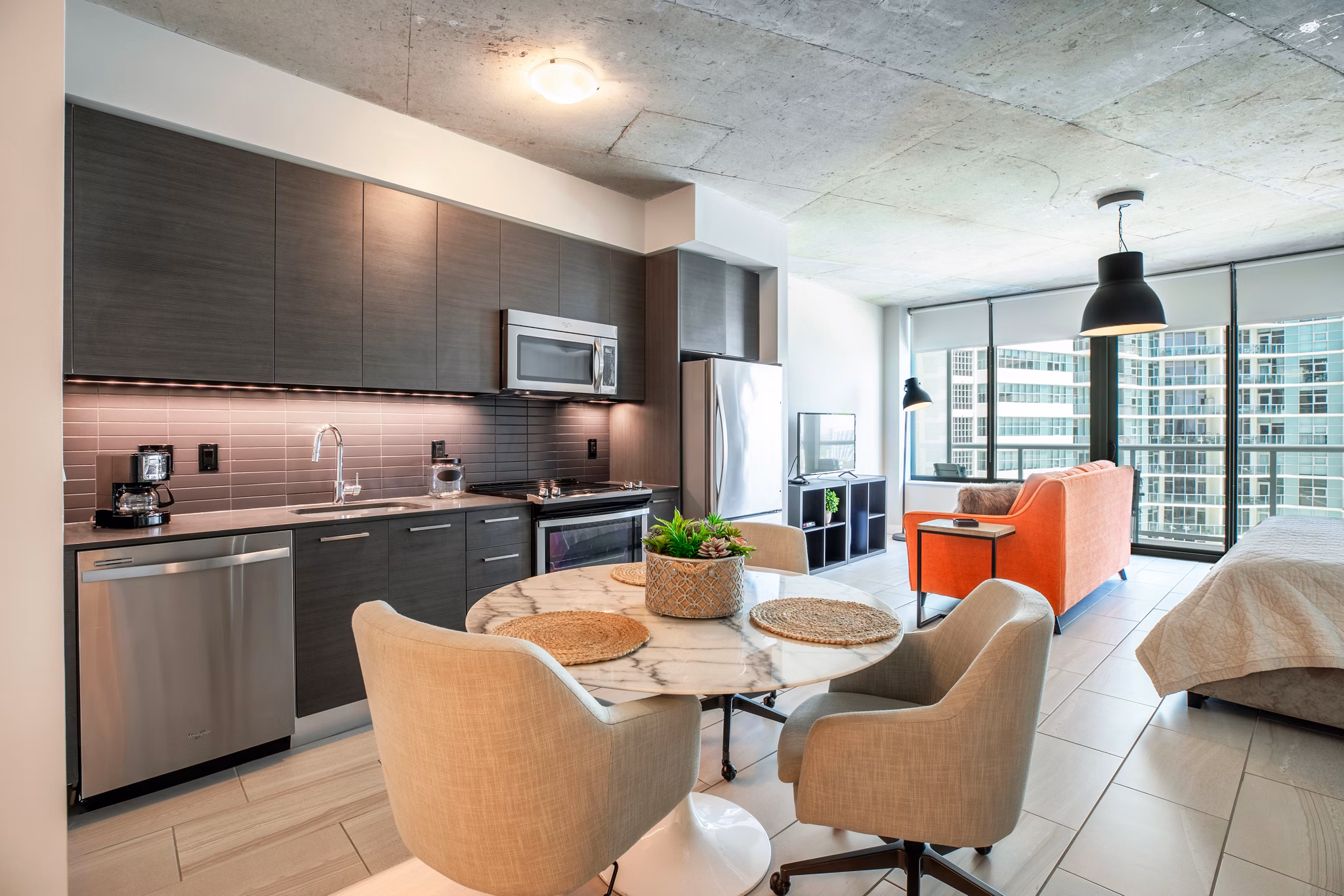 Modern dining area with stylish seating and lighting in Midtown 5 Apartments