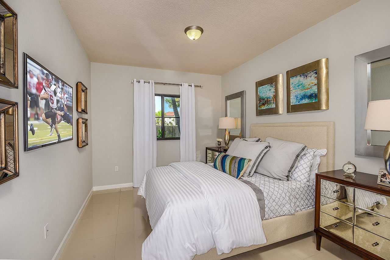 Bedroom featuring modern decor and natural light at Celebration Pointe Apartments