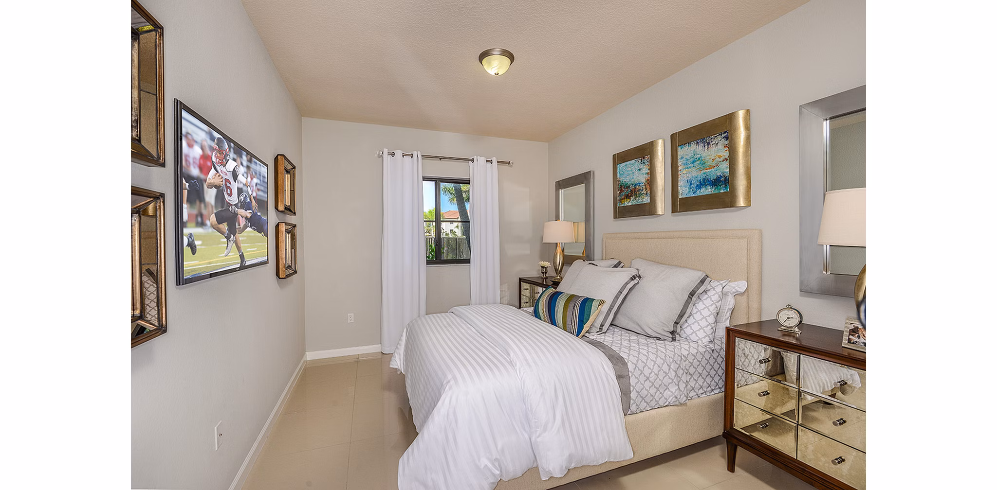 Bedroom featuring modern decor and natural light at Celebration Pointe Apartments