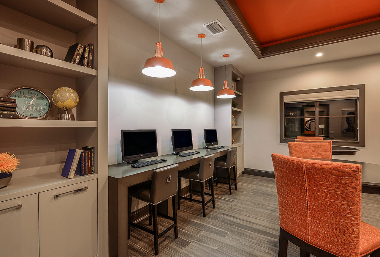 Business center with modern workstations at Celebration Pointe Apartments