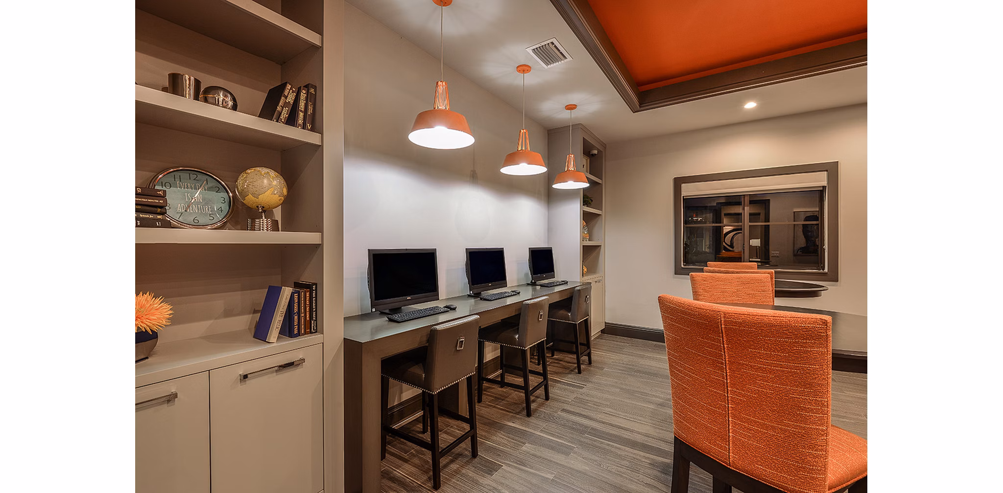 Business center with modern workstations at Celebration Pointe Apartments