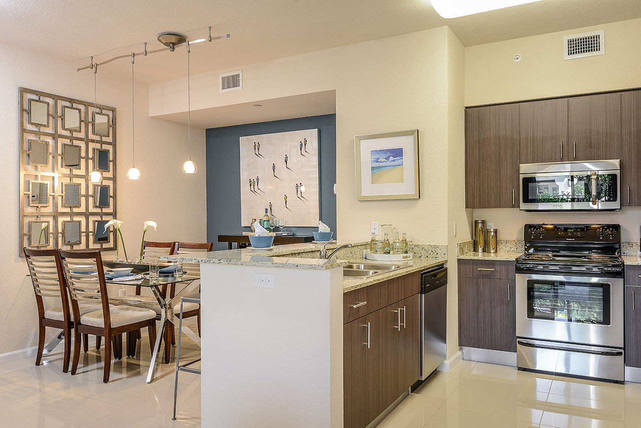Modern kitchen featuring stainless steel appliances at Celebration Pointe Apartments