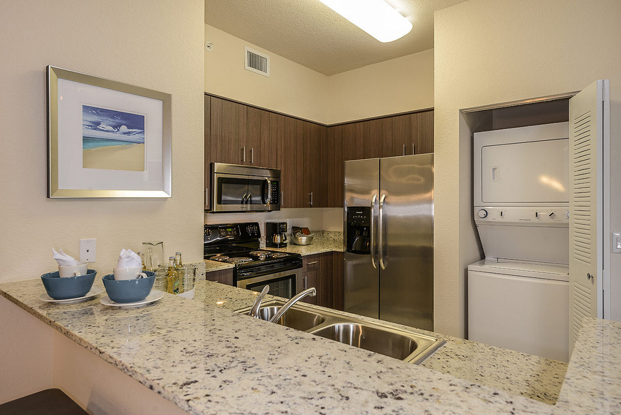Modern kitchen with stainless steel appliances in Celebration Pointe Apartments luxury residences