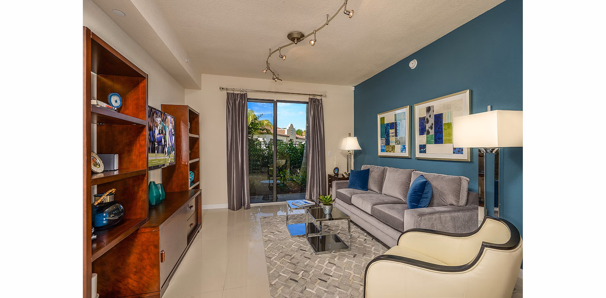 Spacious living room with modern decor in Celebration Pointe Apartments, featuring luxury finishes and ample natural light