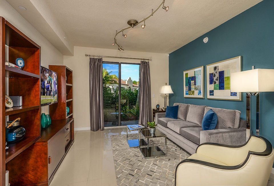 Spacious living room with modern decor in Celebration Pointe Apartments, featuring luxury finishes and ample natural light