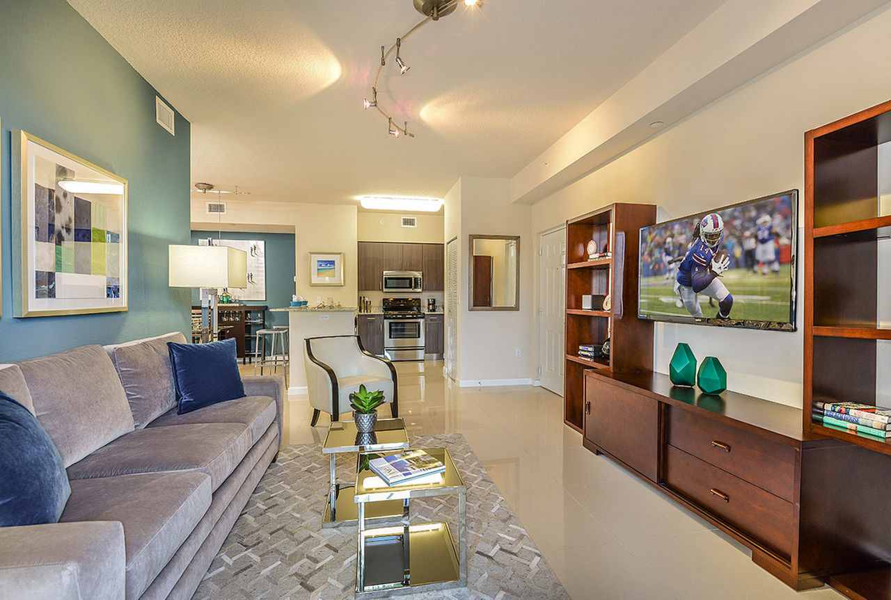 Spacious living room with contemporary design features at Celebration Pointe Apartments