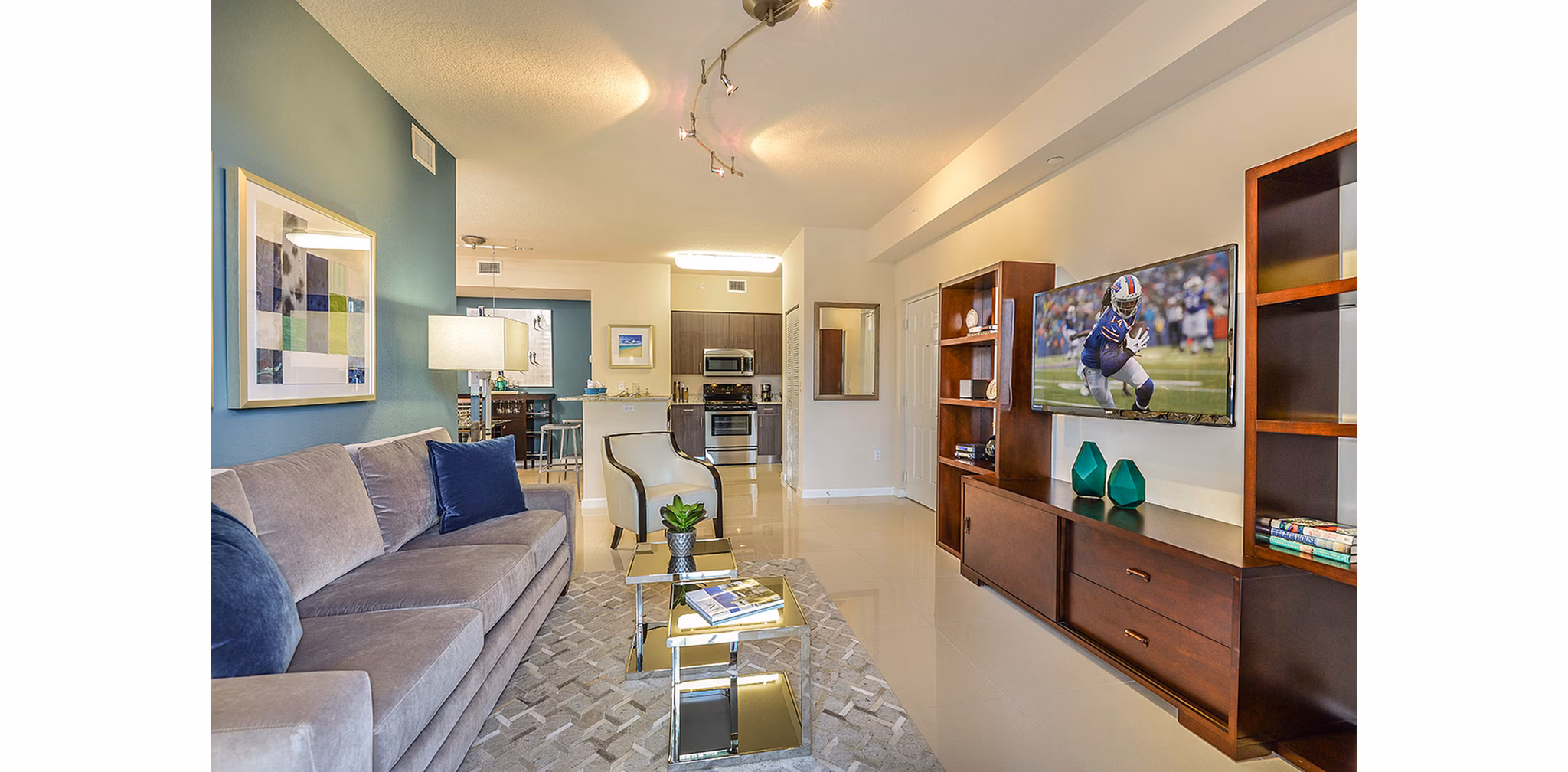 Spacious living room with contemporary design features at Celebration Pointe Apartments