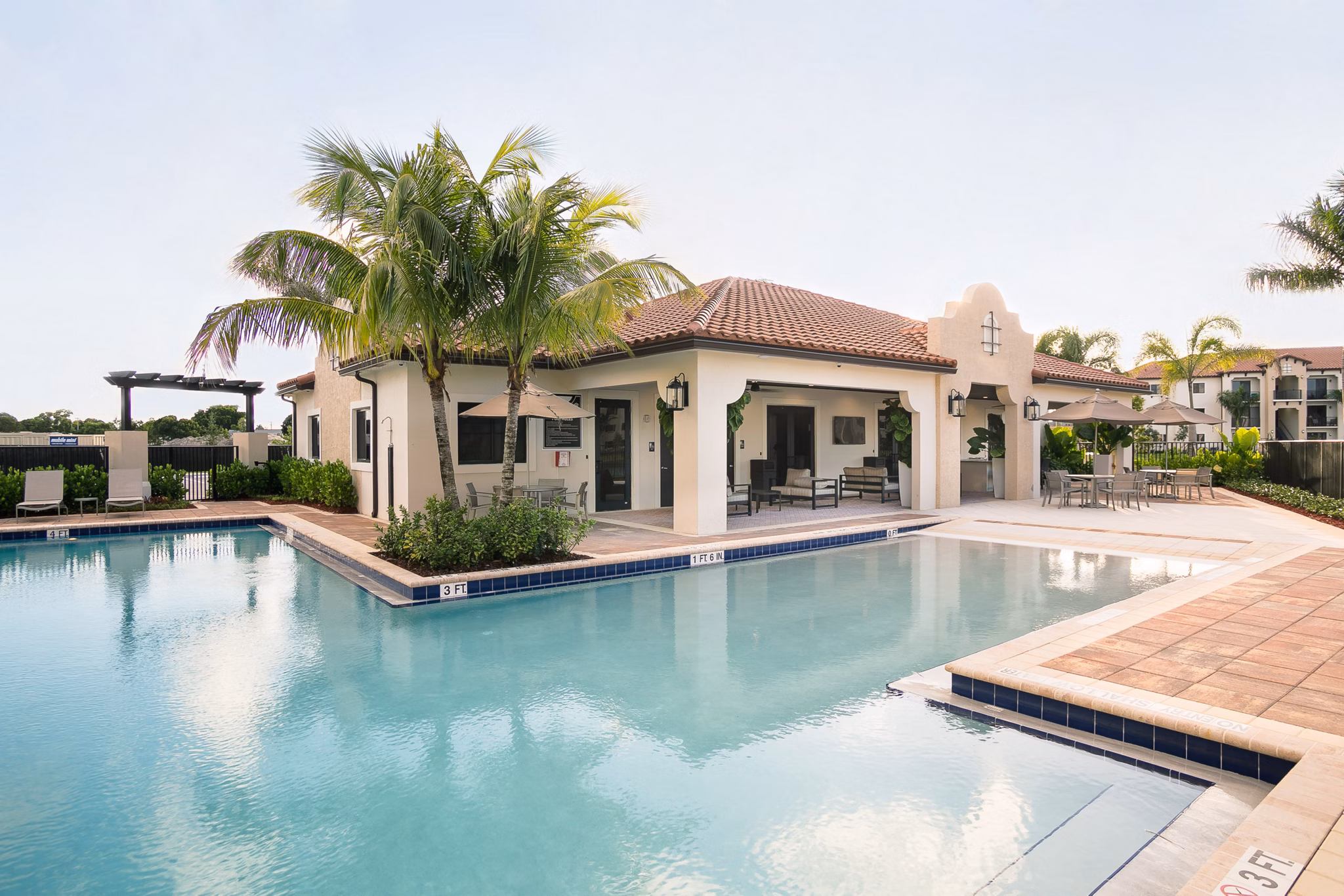 Luxurious pool with lounge chairs at Celebration Pointe Apartments, a premier living community