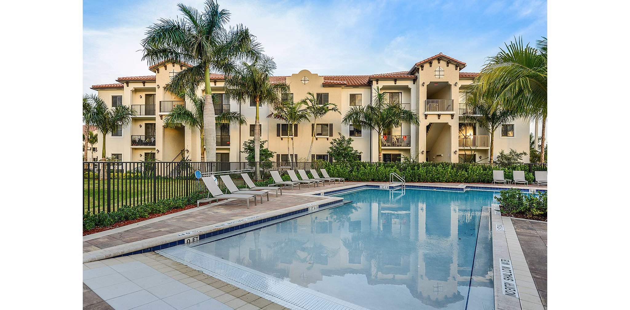 Luxurious outdoor pool with lounge chairs at Celebration Pointe Apartments, perfect for relaxation and recreation