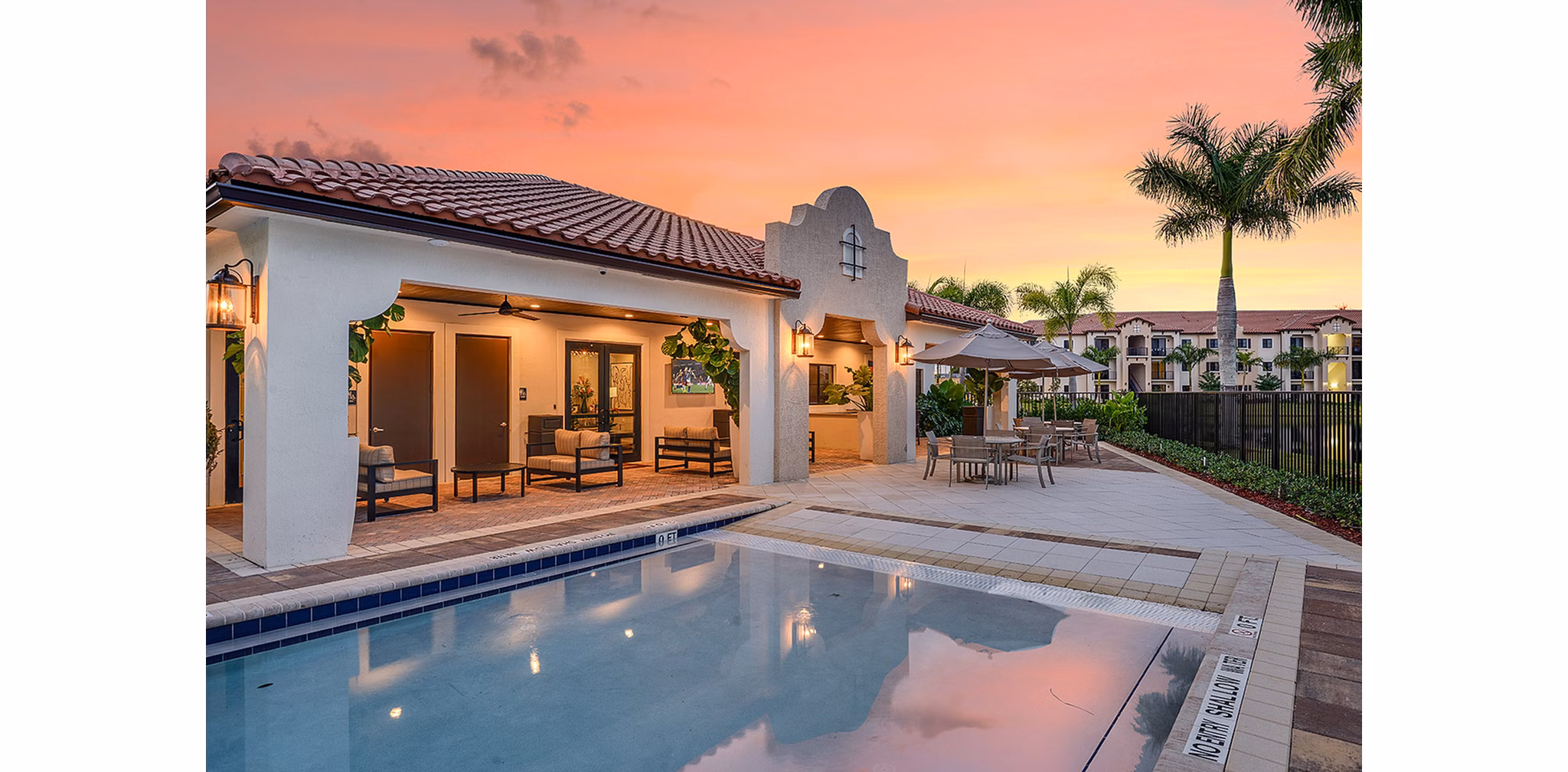 Luxurious swimming pool with lounge chairs at Celebration Pointe Apartments