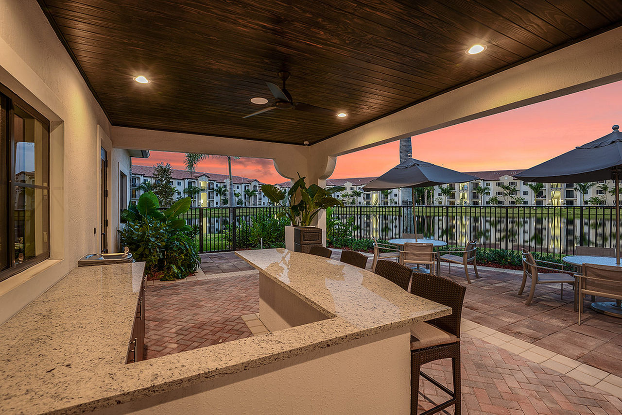 Cozy outdoor patio with seating area at Celebration Pointe Apartments