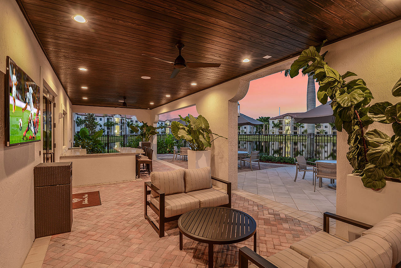 Charming patio with modern seating at Celebration Pointe Apartments, an inviting space for residents to relax outdoors