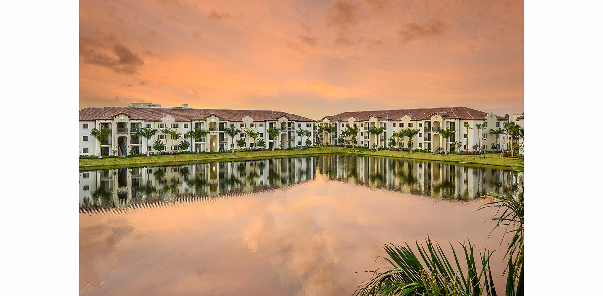 Celebration Pointe Apartments: Scenic view of luxury apartments with lush landscaping