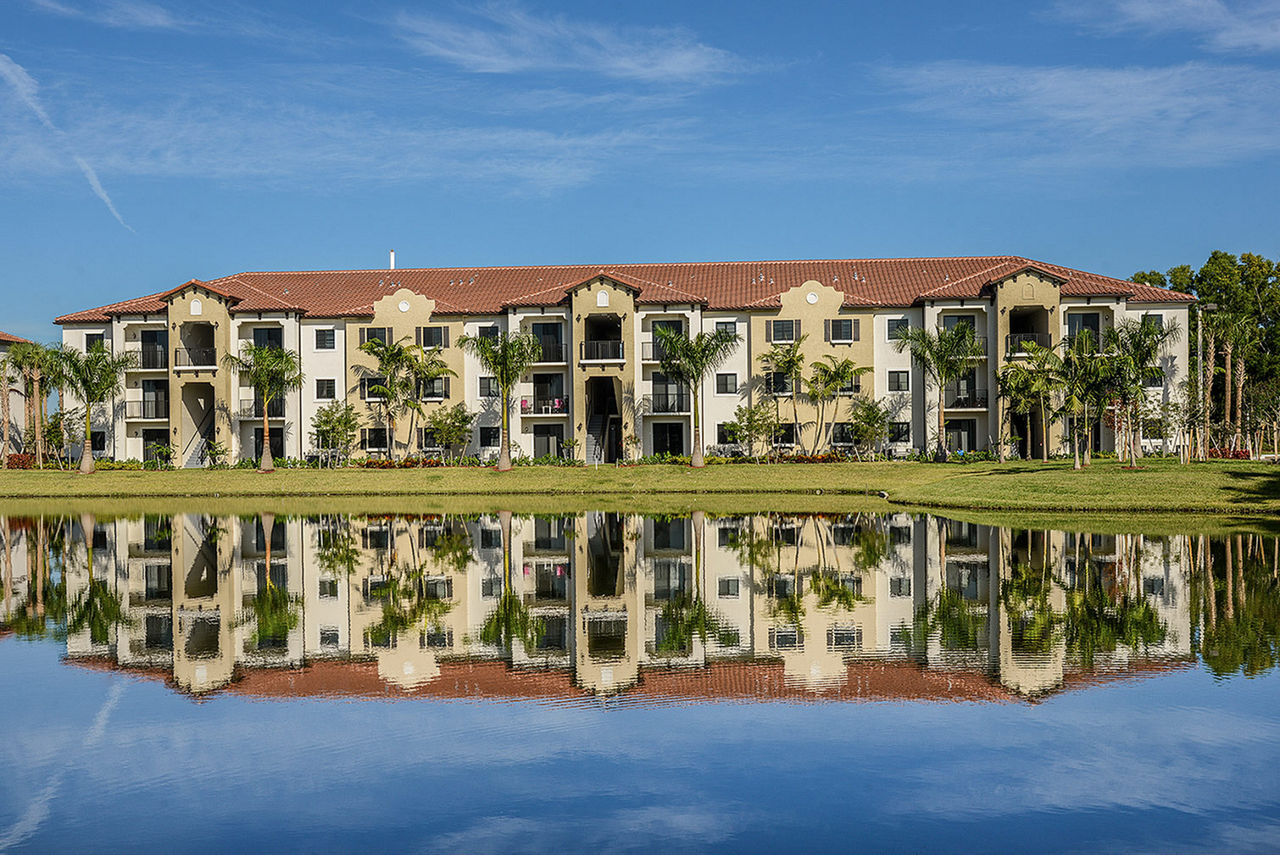 Celebration Pointe Apartments: Scenic view of the landscaped gardens from a luxury balcony, enhancing the serene living experience