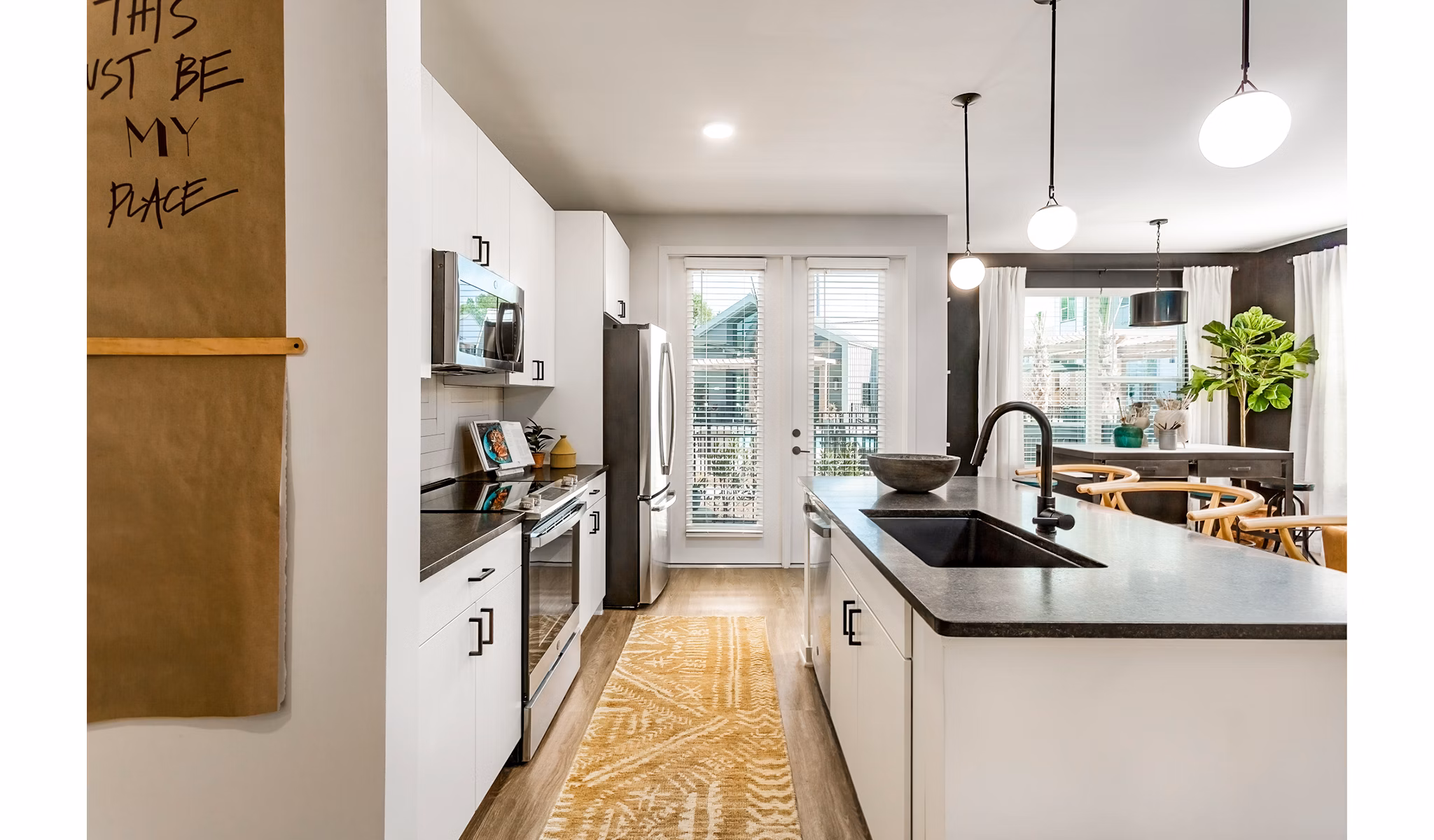 Modern kitchen with stainless steel appliances and granite countertops at The Monty Apartments