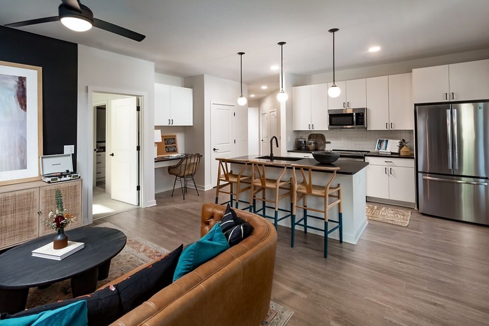 Cozy living room with modern decor and large window in The Monty Apartments, offering comfort and style in a premium setting