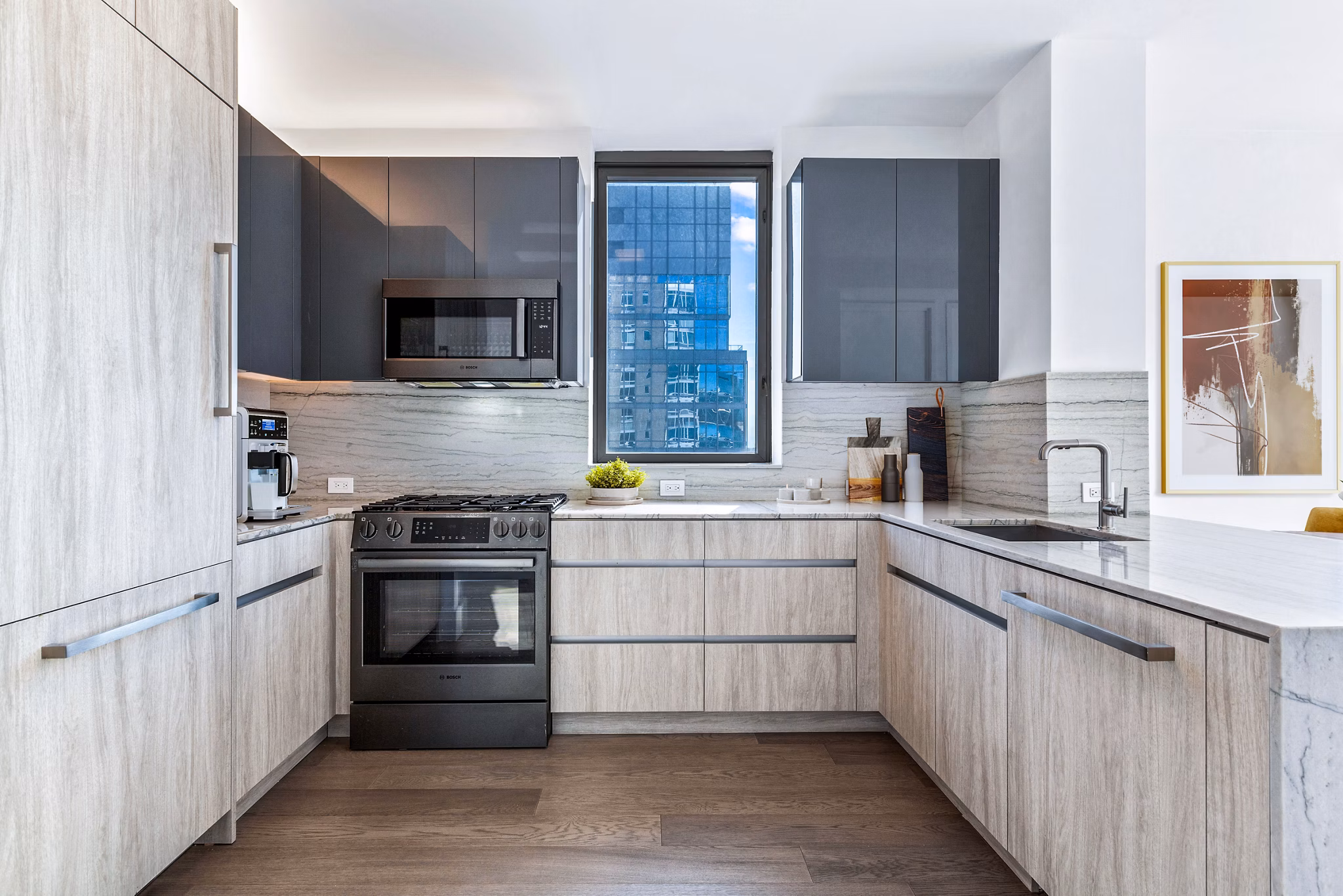 Modern kitchen with stainless steel appliances and sleek countertops at The Biltmore Apartments, a luxury property by Greystar