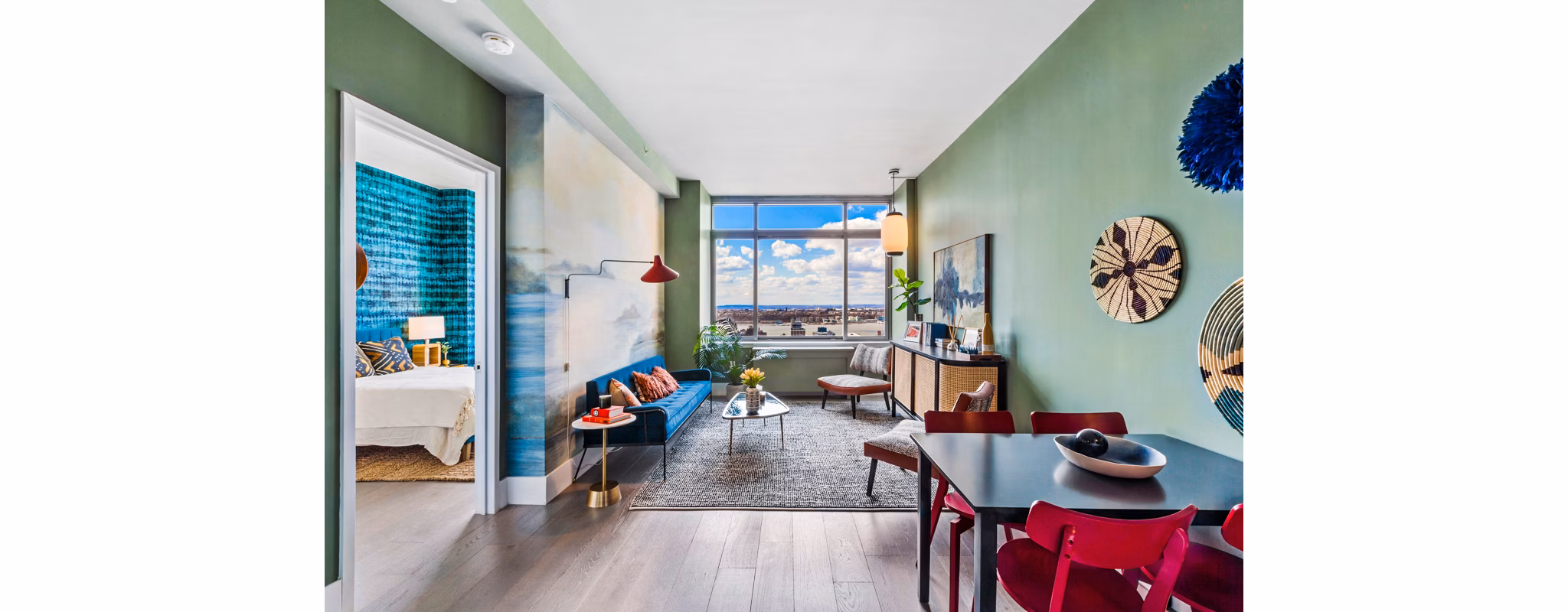 Spacious living room featuring modern decor and large windows at The Biltmore Apartments, luxury residences by Greystar