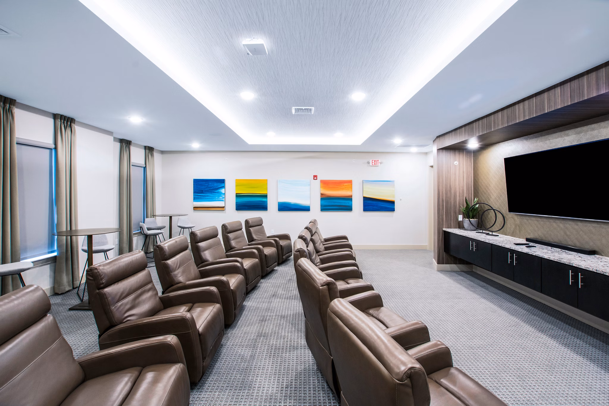 Luxurious theater room with plush seating at Woodgrove at Sterlington Apartments, perfect for entertainment in a modern setting