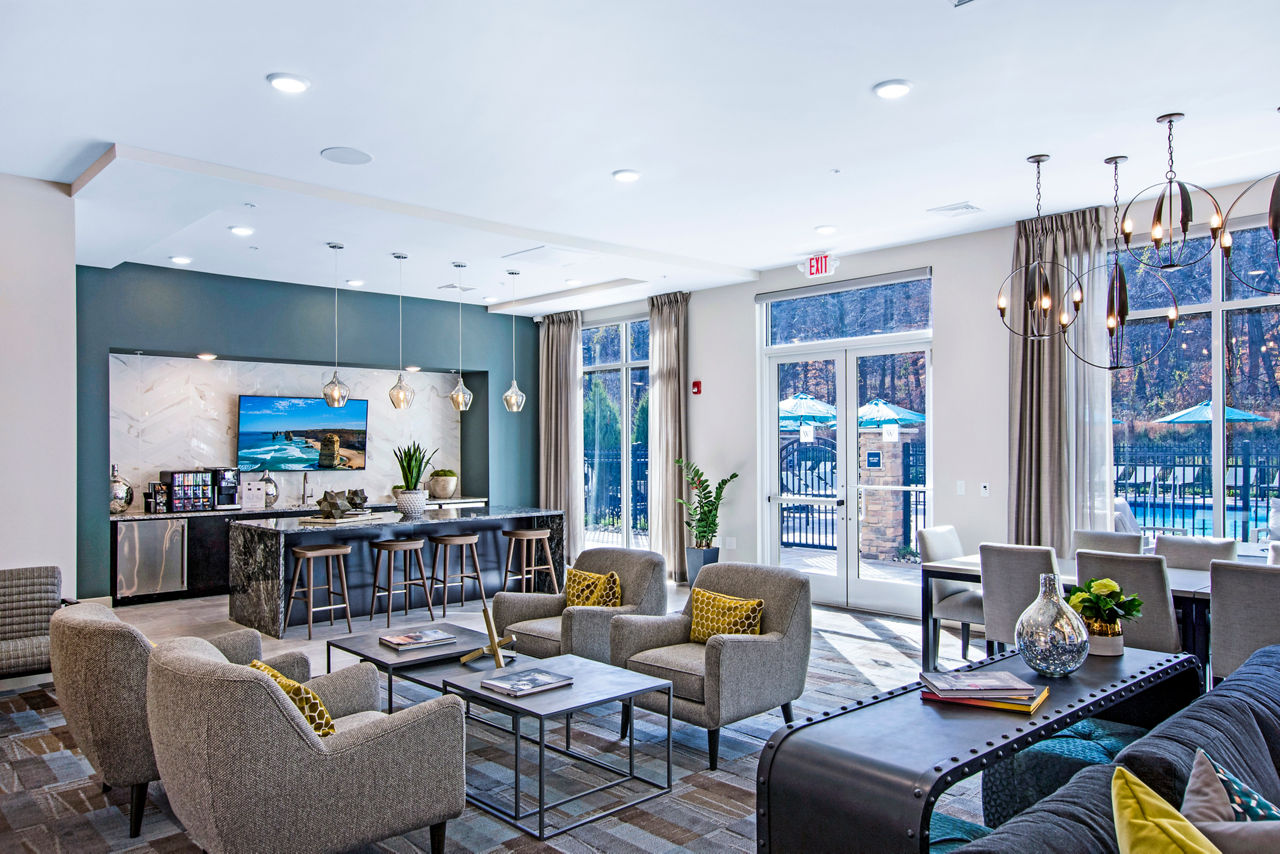 Clubhouse featuring modern decor and seating areas at Woodgrove at Sterlington Apartments