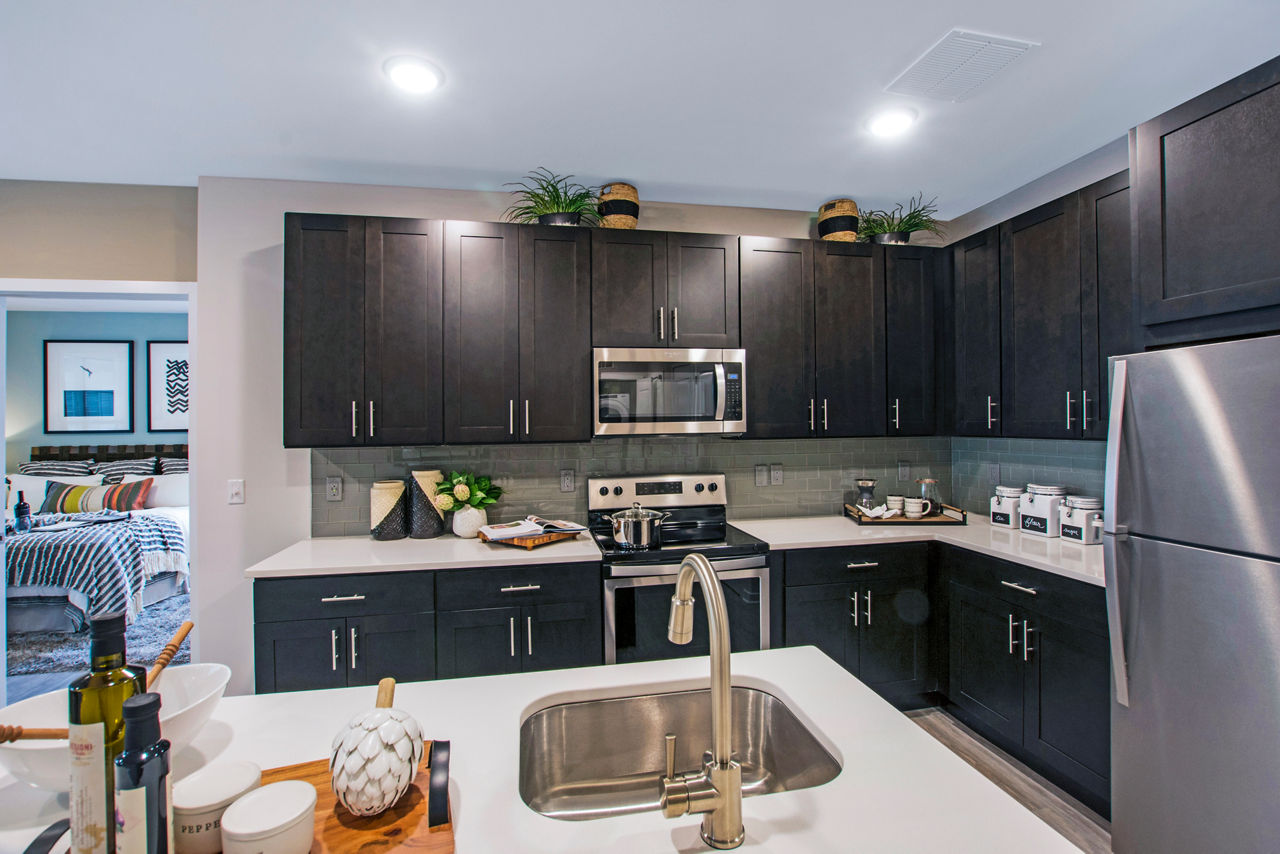 Contemporary kitchen with stainless steel appliances in Woodgrove at Sterlington Apartments