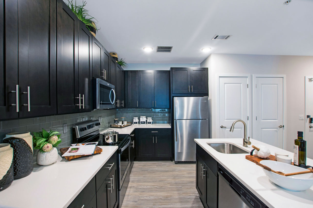 Modern kitchen with stainless steel appliances in Woodgrove at Sterlington Apartments