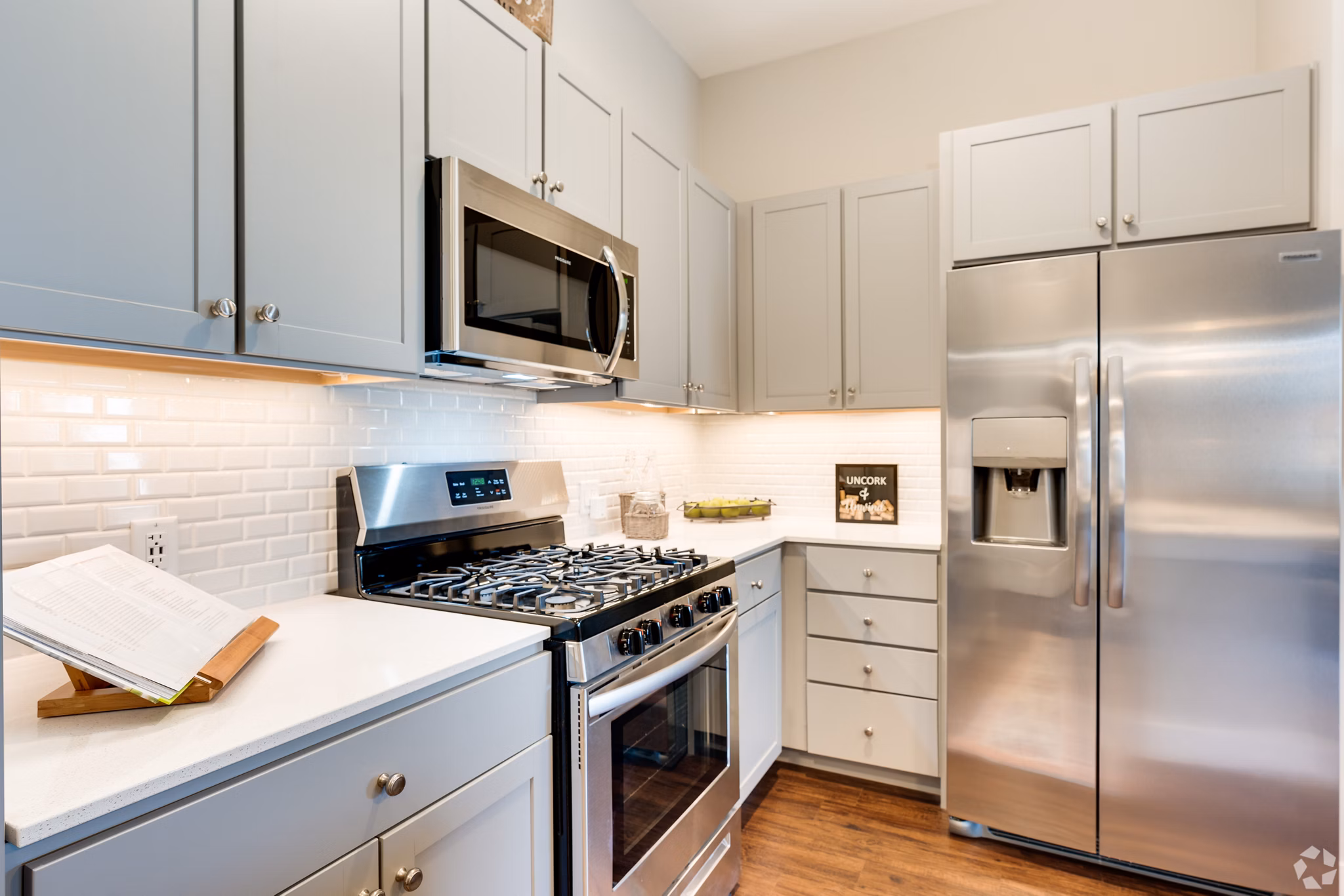 Modern kitchen with stainless steel appliances and granite countertops in Avenida Naperville Apartments