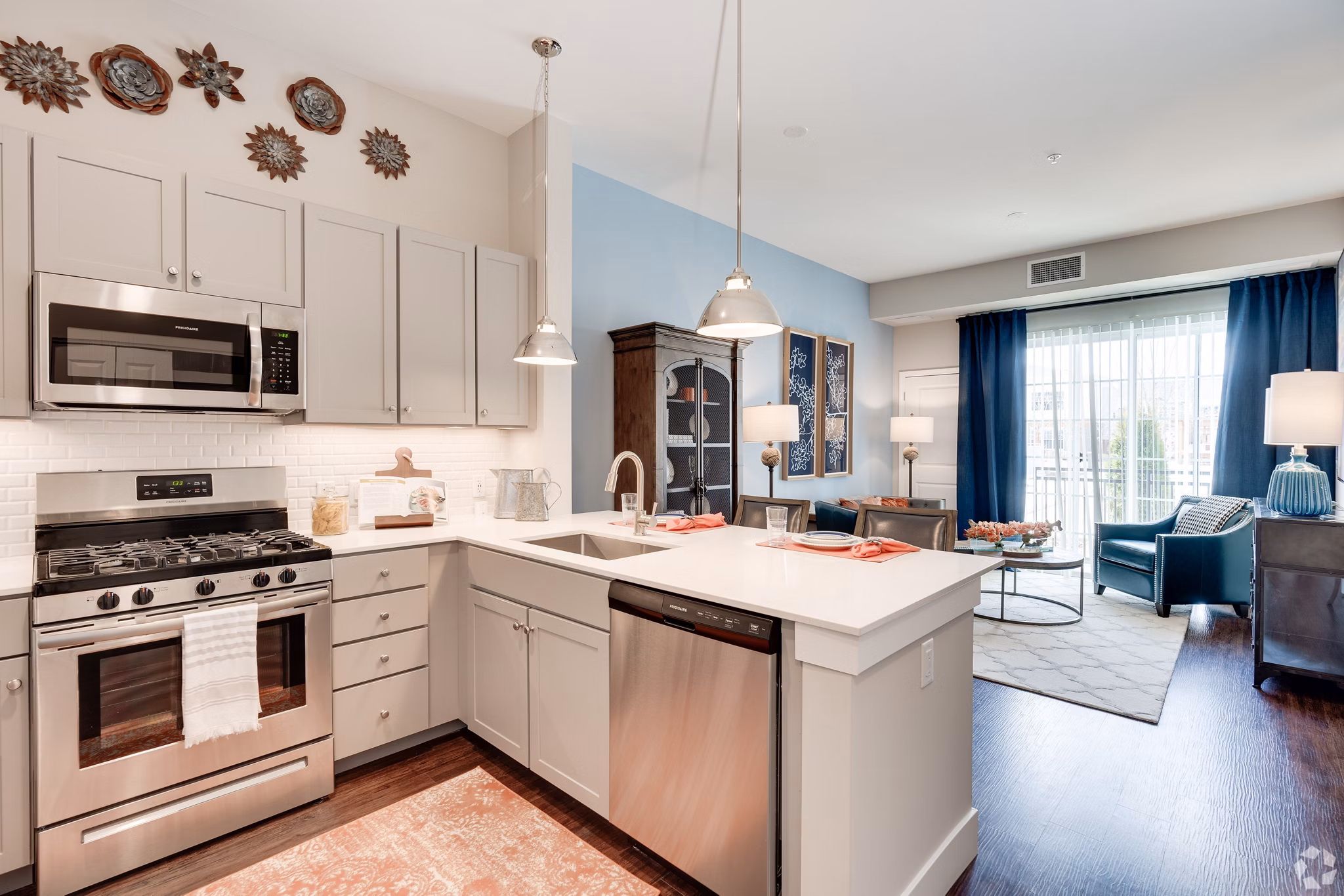 Modern kitchen featuring stainless steel appliances and granite countertops at Avenida Naperville Apartments
