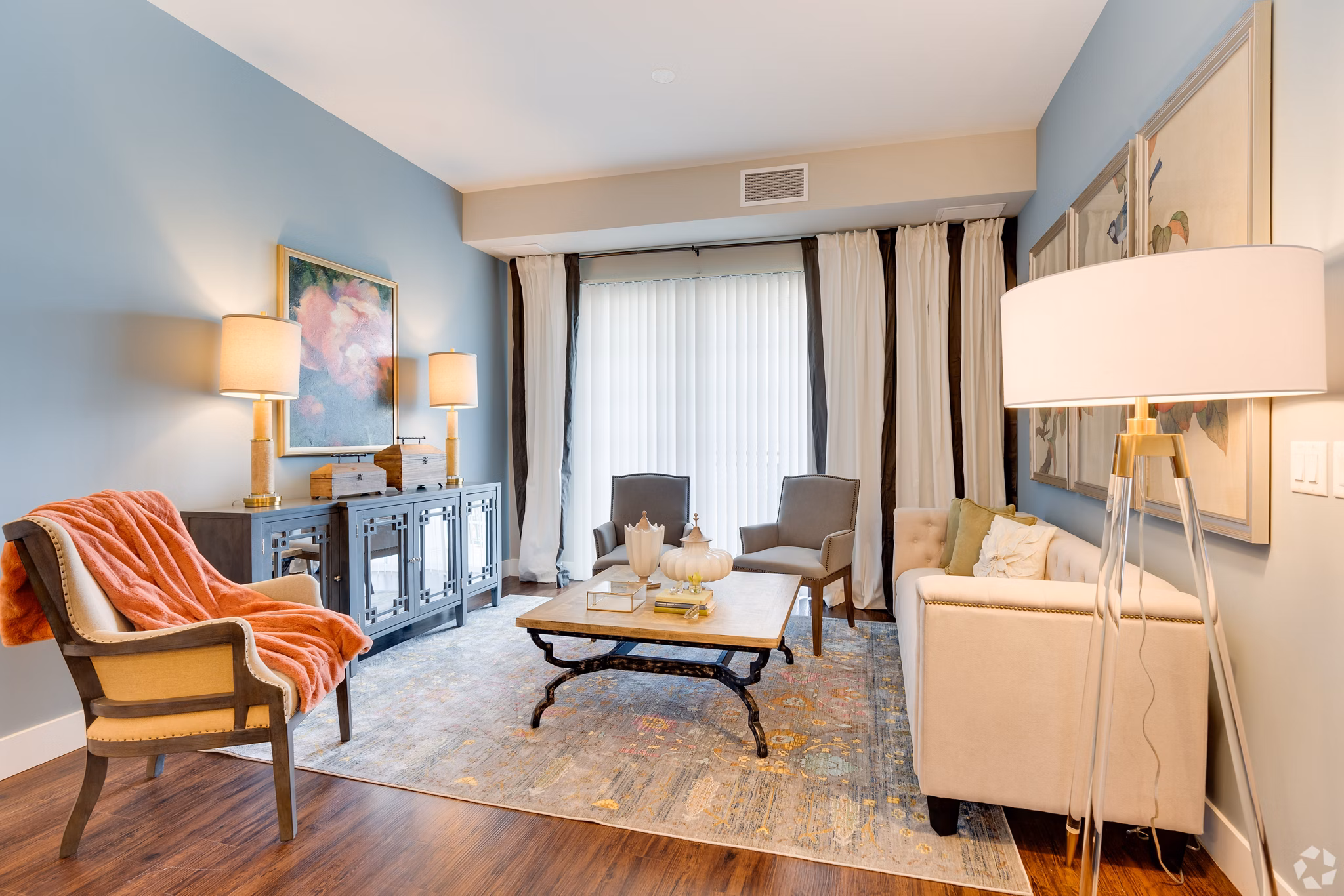 Living room with modern decor and ample natural light at Avenida Naperville Apartments