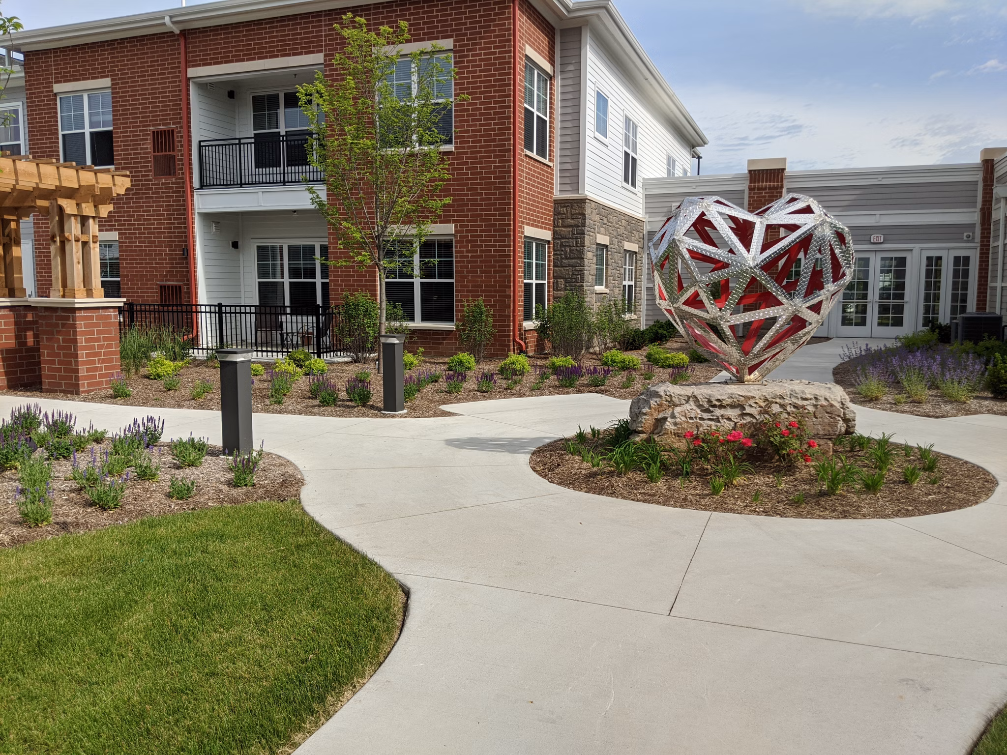 Courtyard featuring lush landscaping and seating areas at Avenida Naperville Apartments, ideal for relaxation and community gatherings