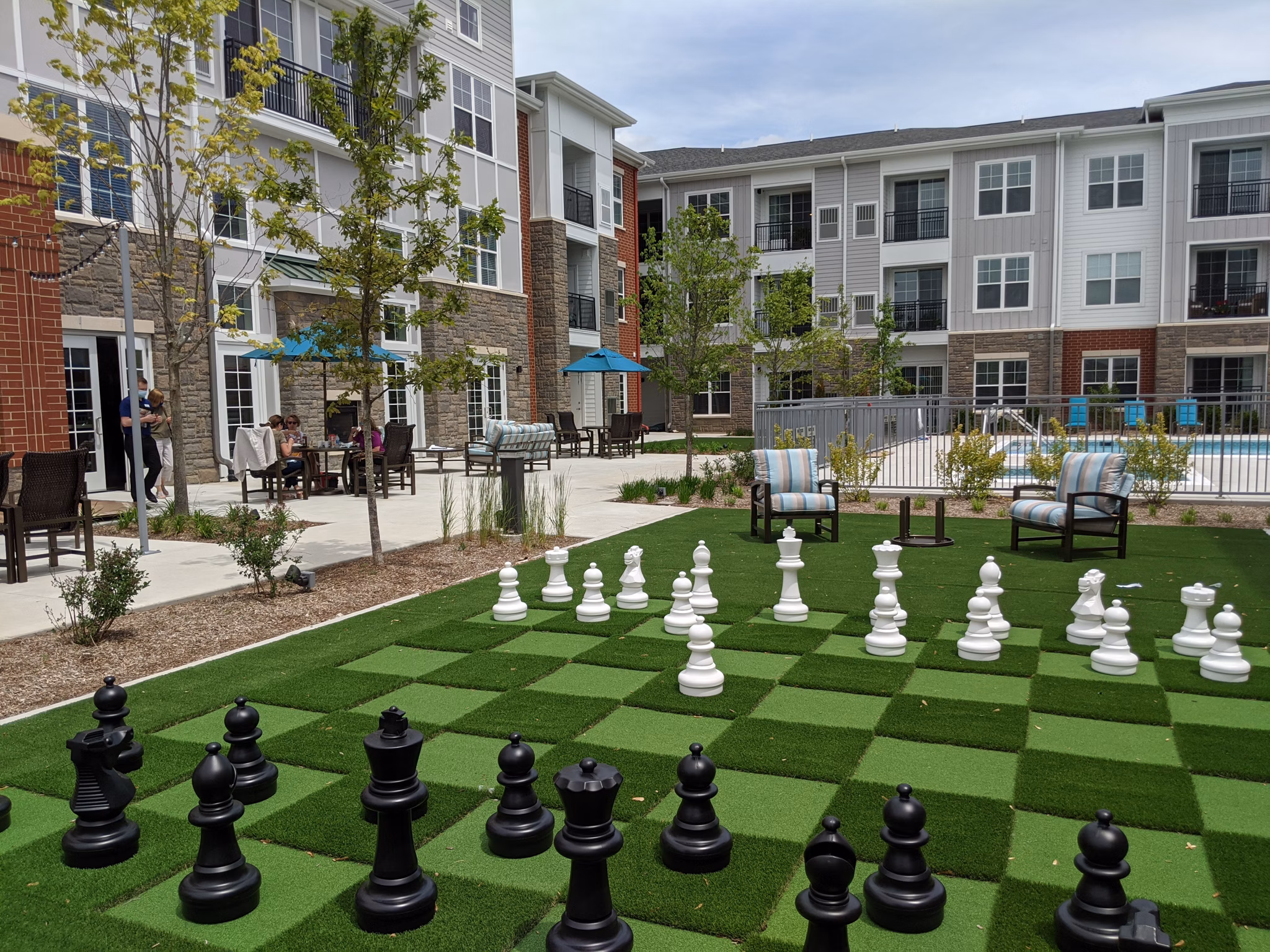 Outdoor sport court at Avenida Naperville Apartments designed for basketball and tennis enthusiasts, offering recreational fun in a vibrant community