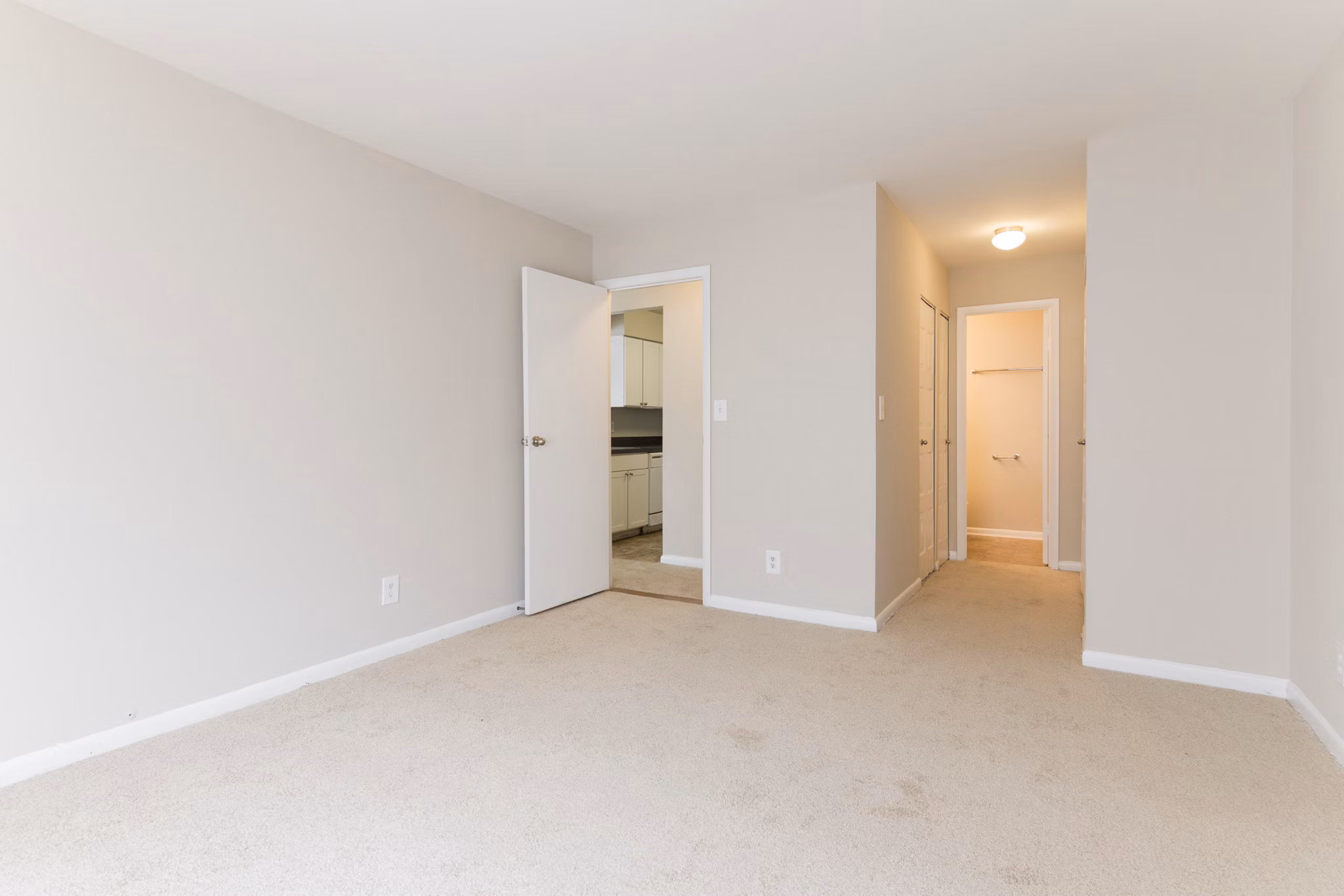 Cozy bedroom with modern decor at Avana Oak Mill Apartments, featuring natural light and elegant furnishings