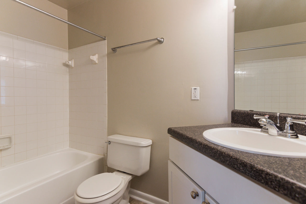 Luxurious bathroom with marble countertops and modern fixtures at Avana Oak Mill Apartments