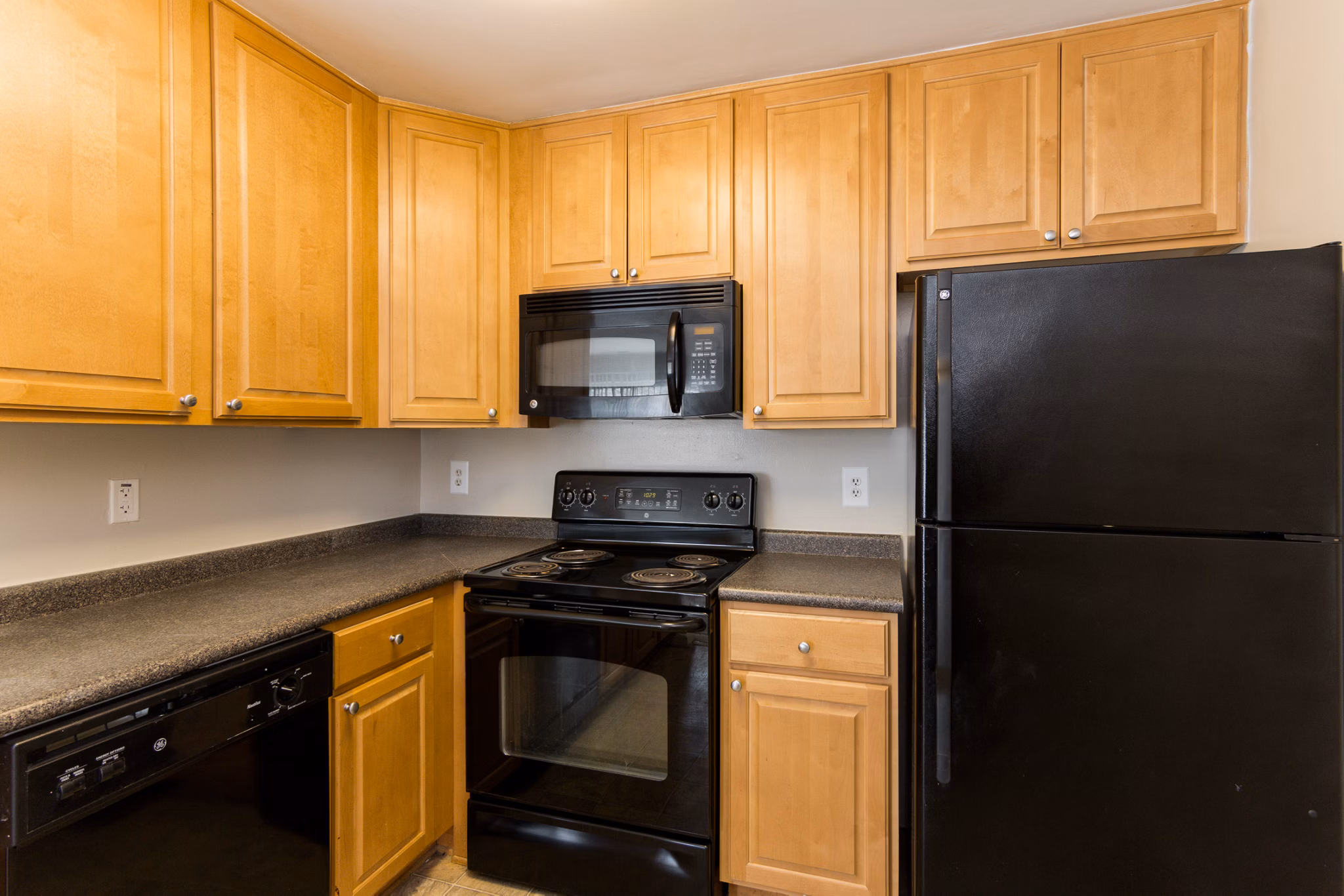 Modern kitchen with stainless steel appliances in Avana Oak Mill Apartments