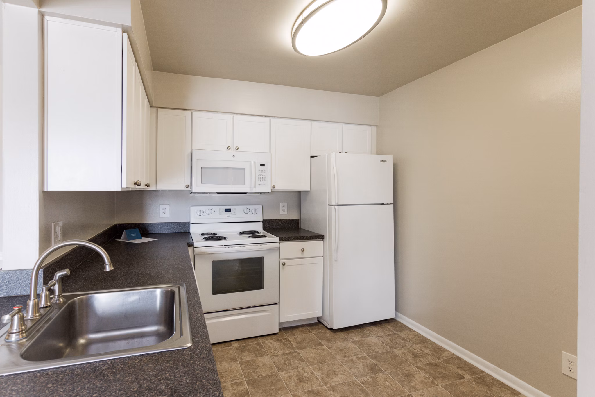 Modern kitchen with stainless steel appliances at Avana Oak Mill Apartments, ideal for luxury living