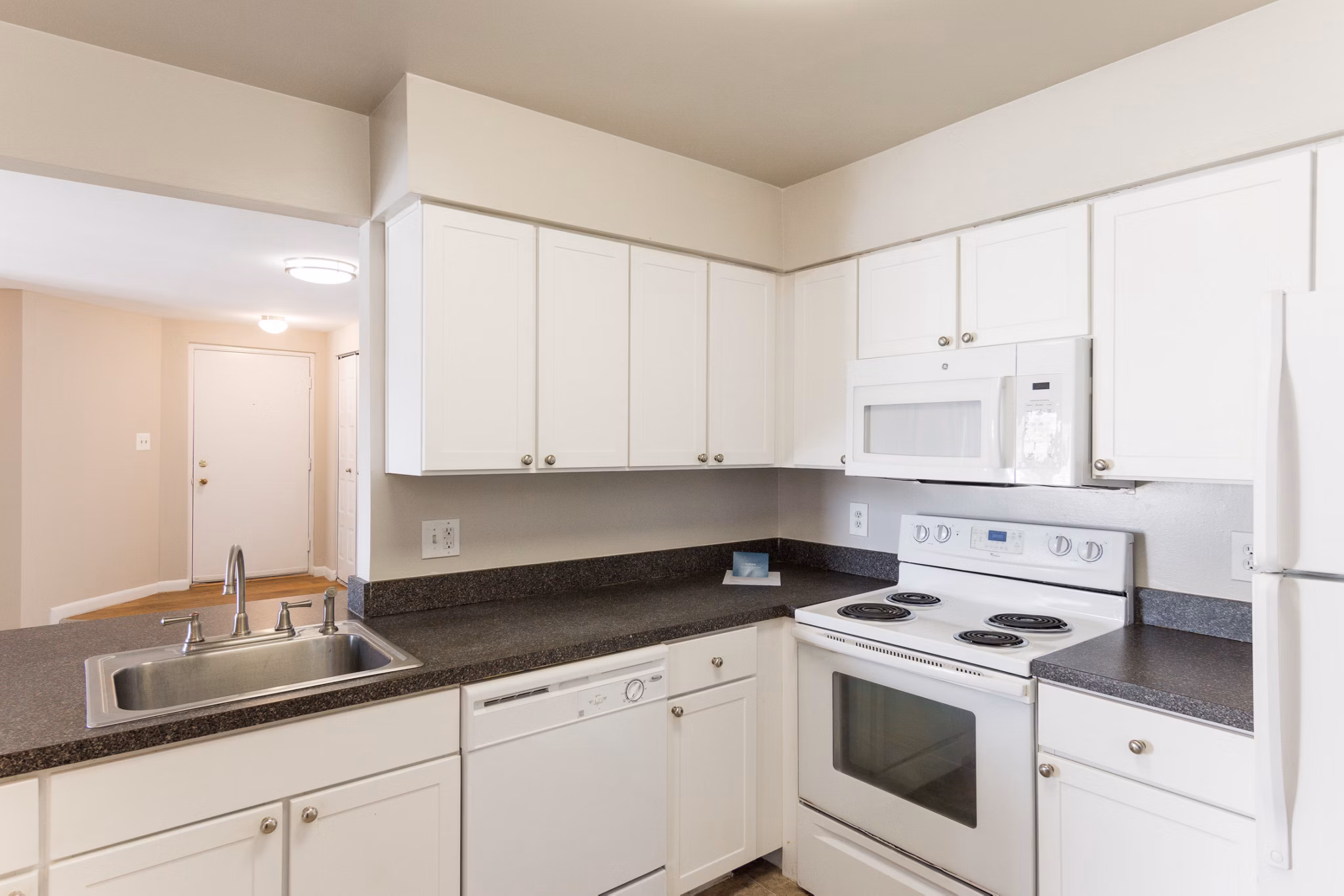 Modern kitchen with stainless steel appliances in Avana Oak Mill Apartments